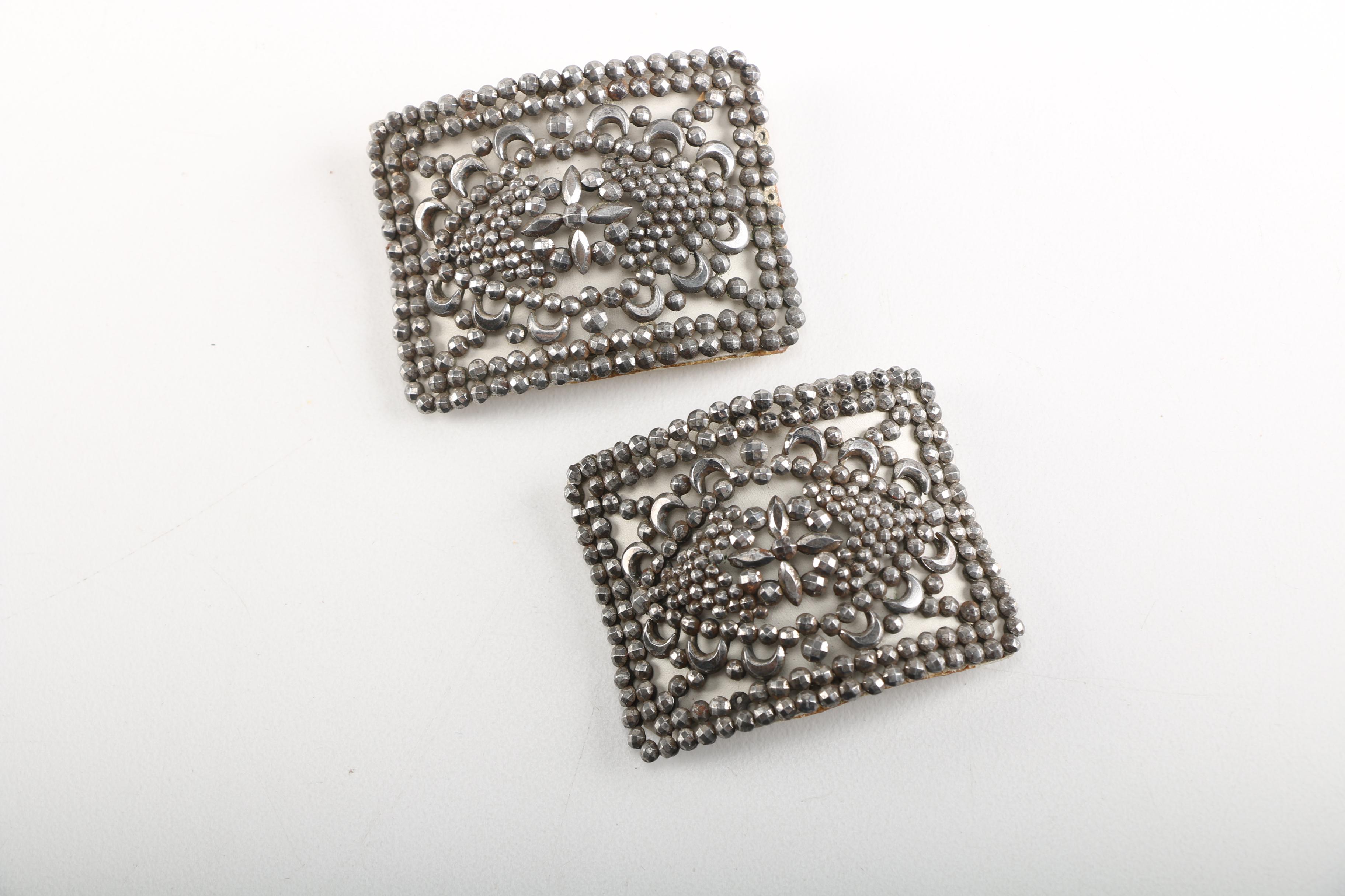 Assortment of Earrings Featuring a Pair Belt Buckles