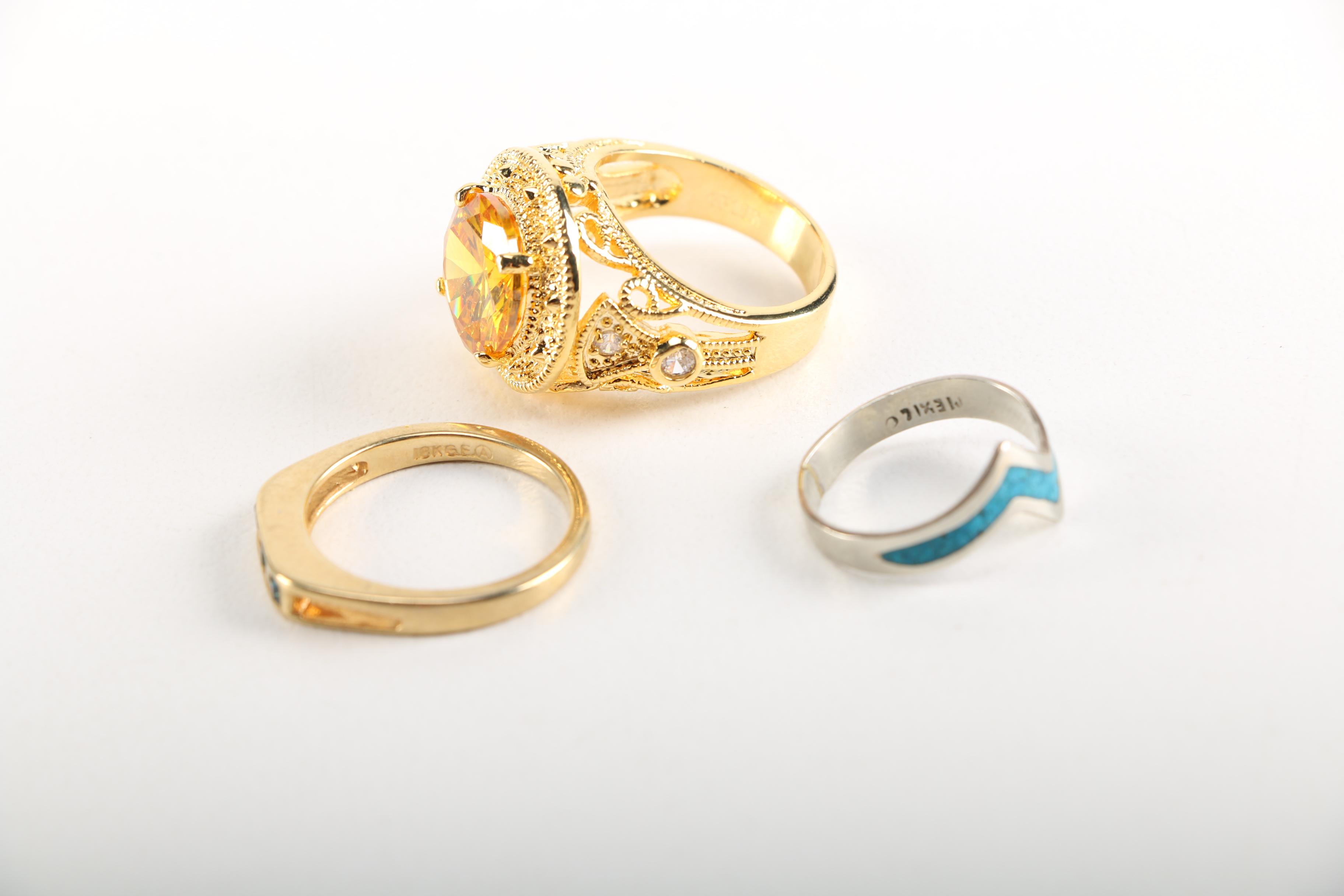 Assortment of Earrings Featuring a Pair Belt Buckles