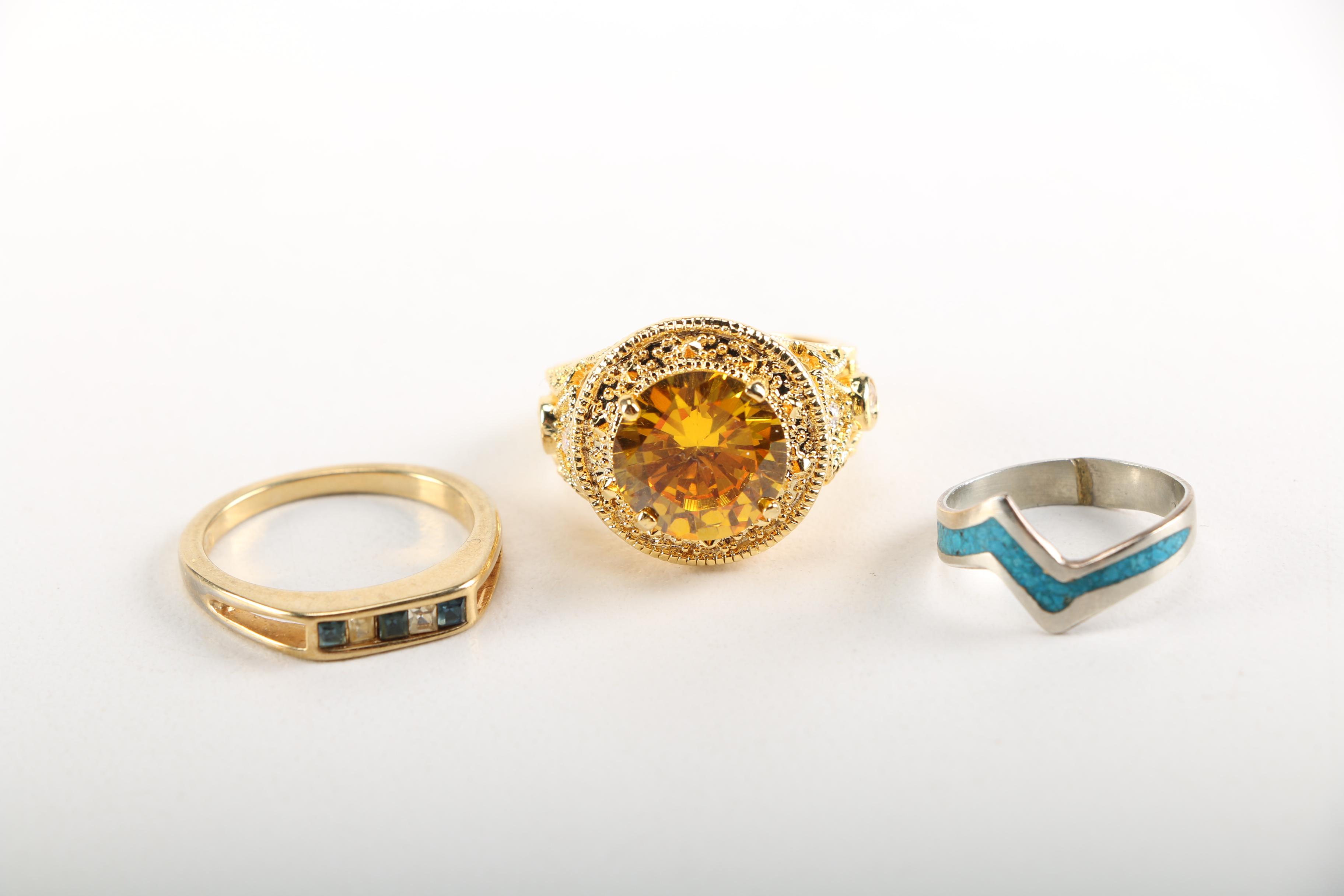 Assortment of Earrings Featuring a Pair Belt Buckles