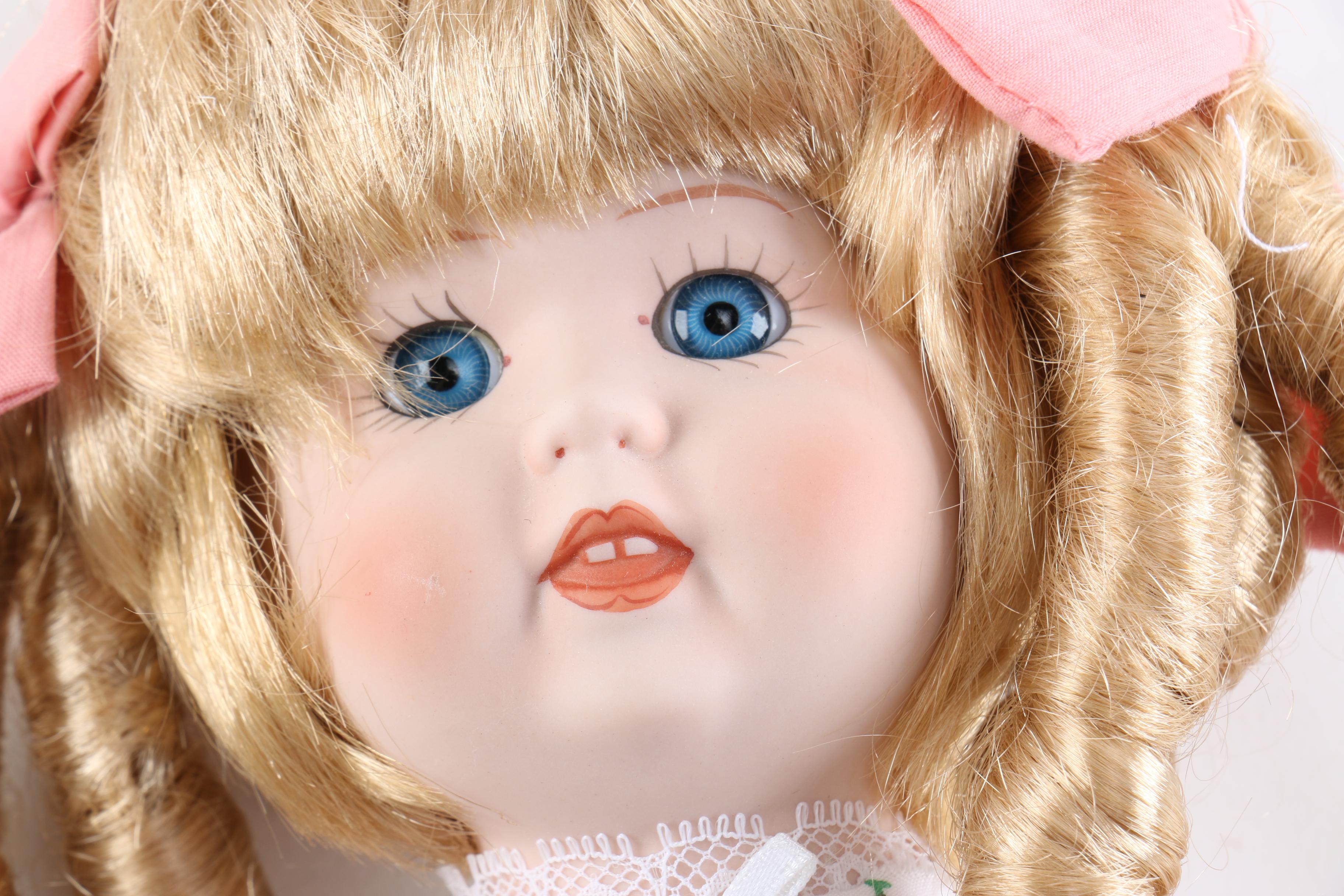 Porcelain Dolls Including a Dynasty Doll with Matching Bear