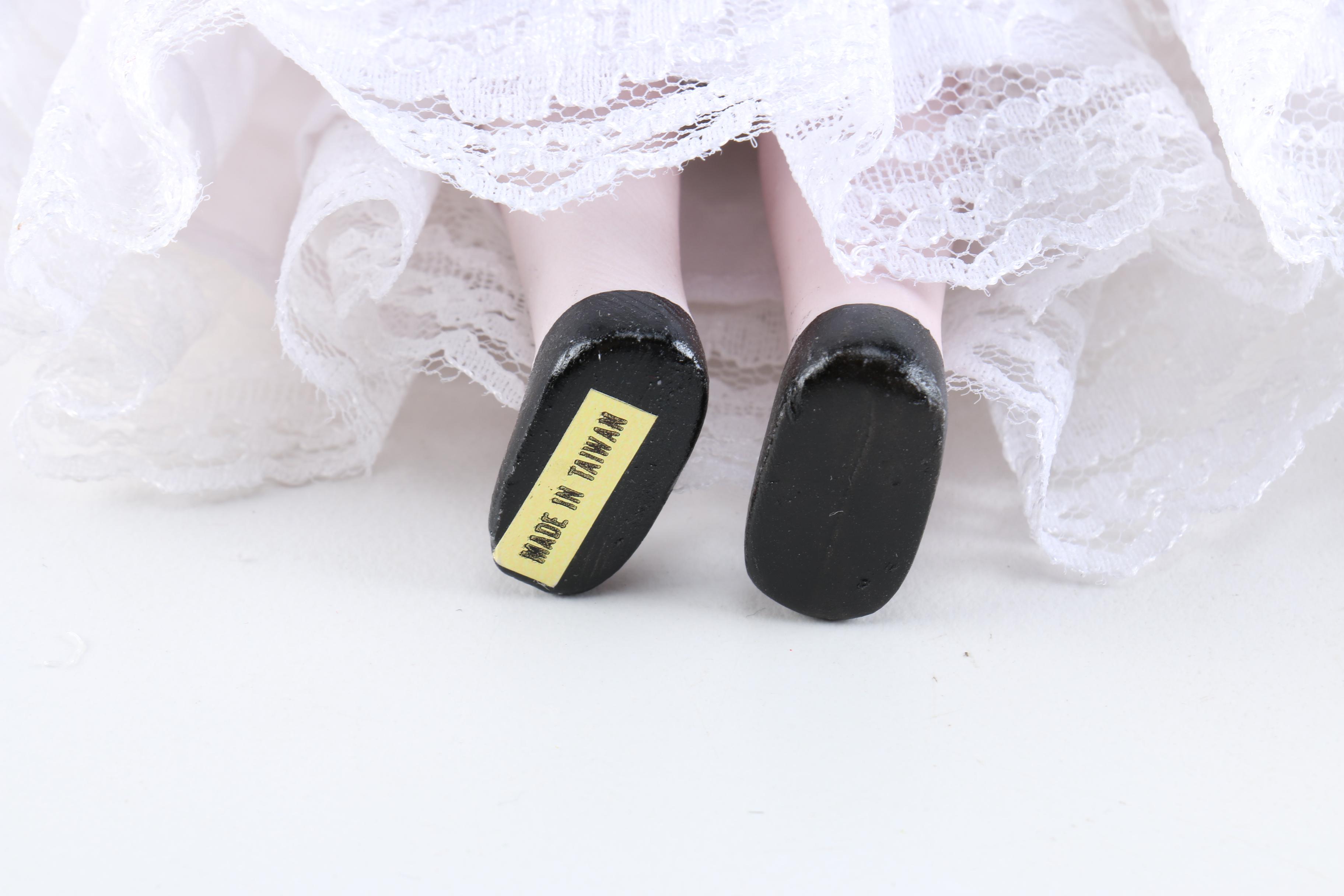 Porcelain Dolls Including a Dynasty Doll with Matching Bear