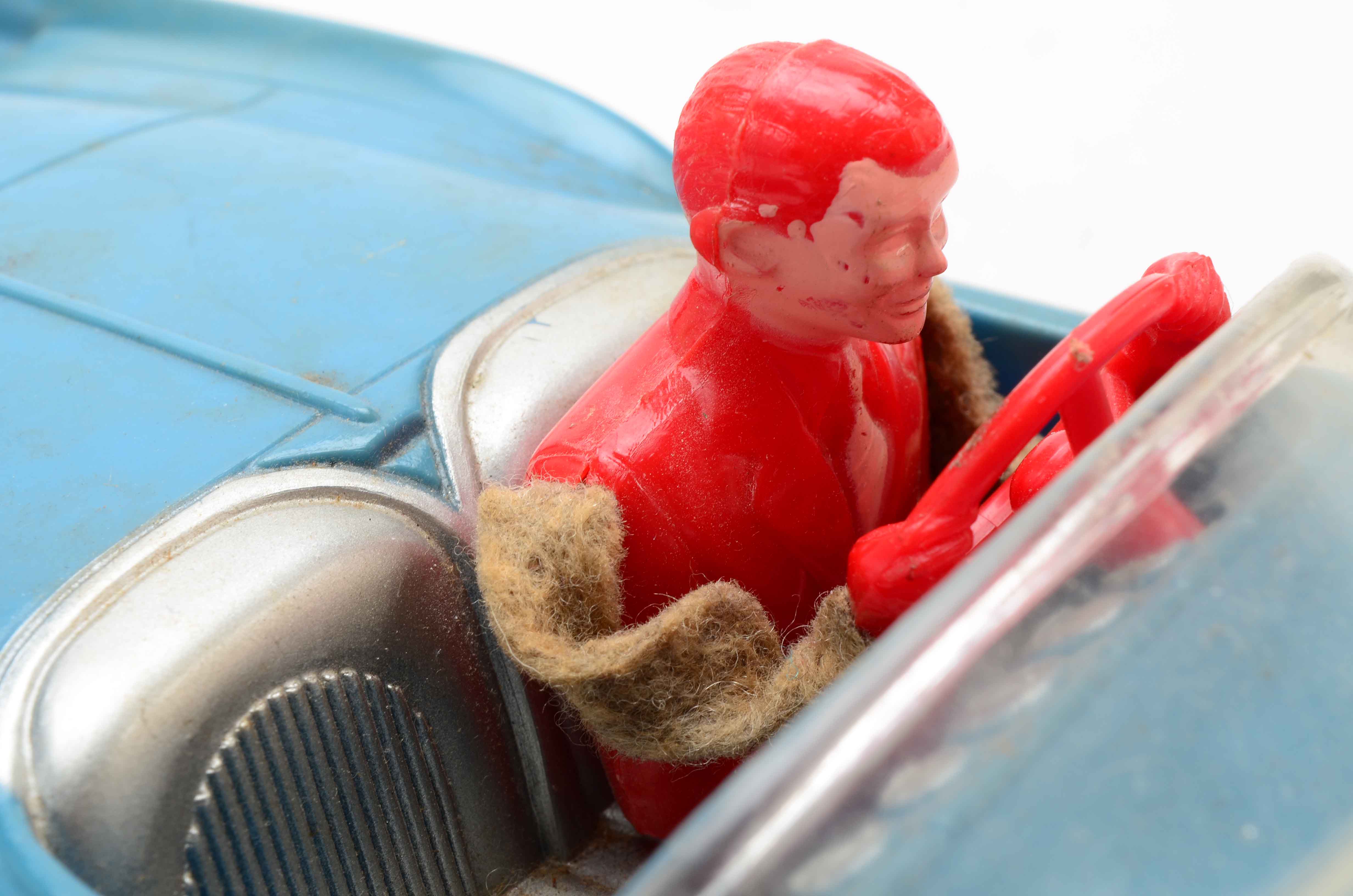 Vintage Blue Car with Yellow Rocket