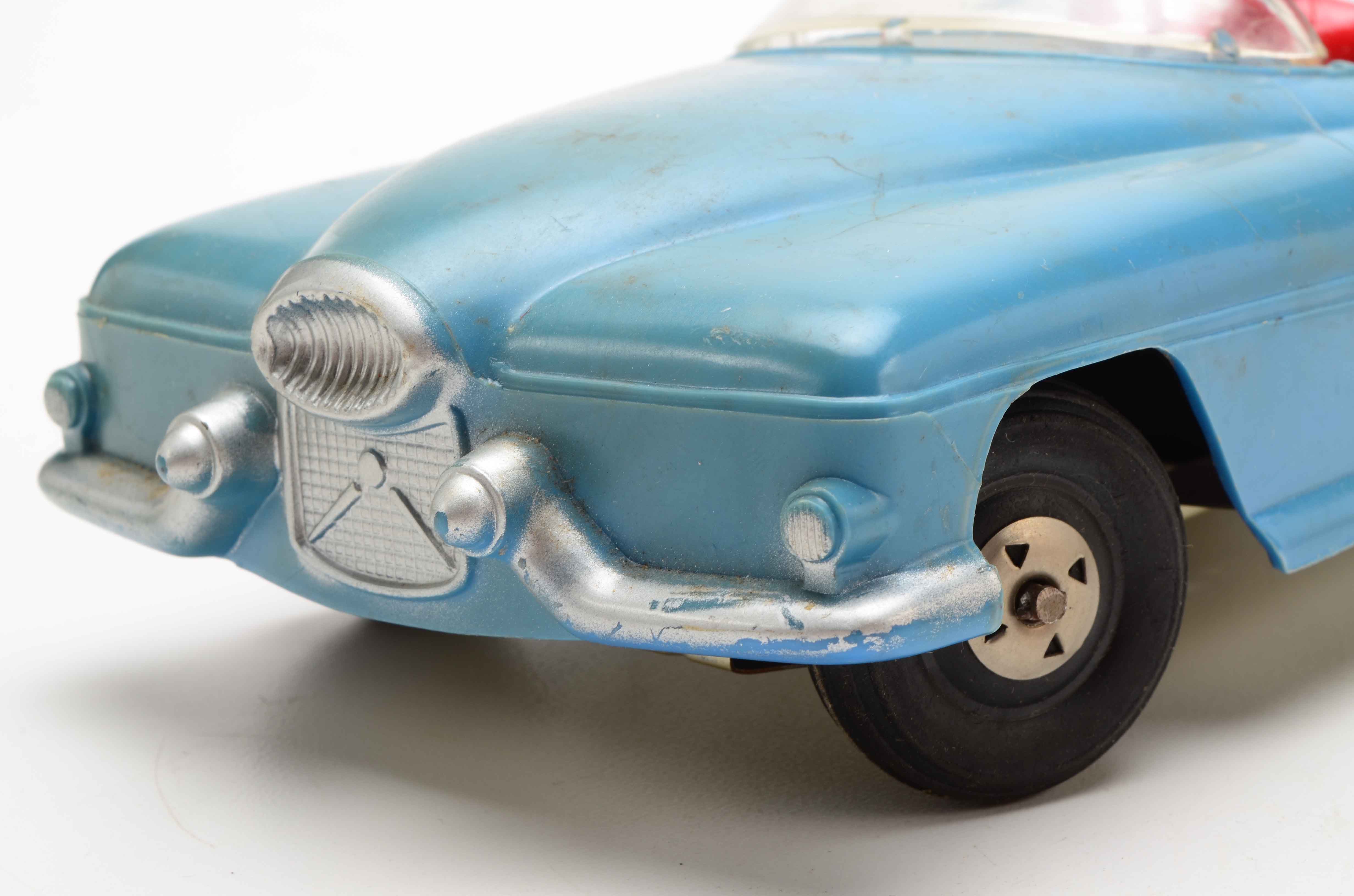 Vintage Blue Car with Yellow Rocket