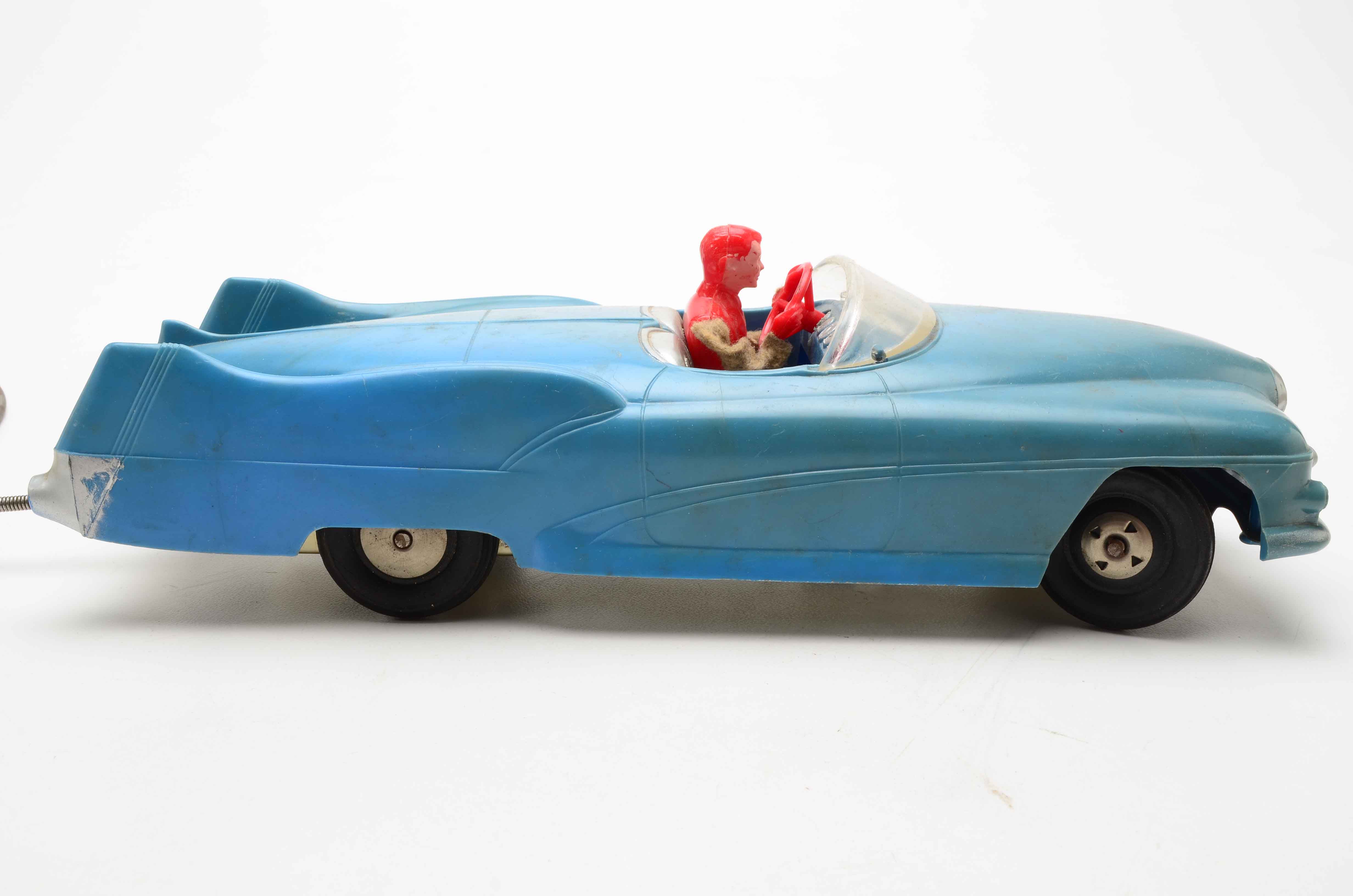 Vintage Blue Car with Yellow Rocket