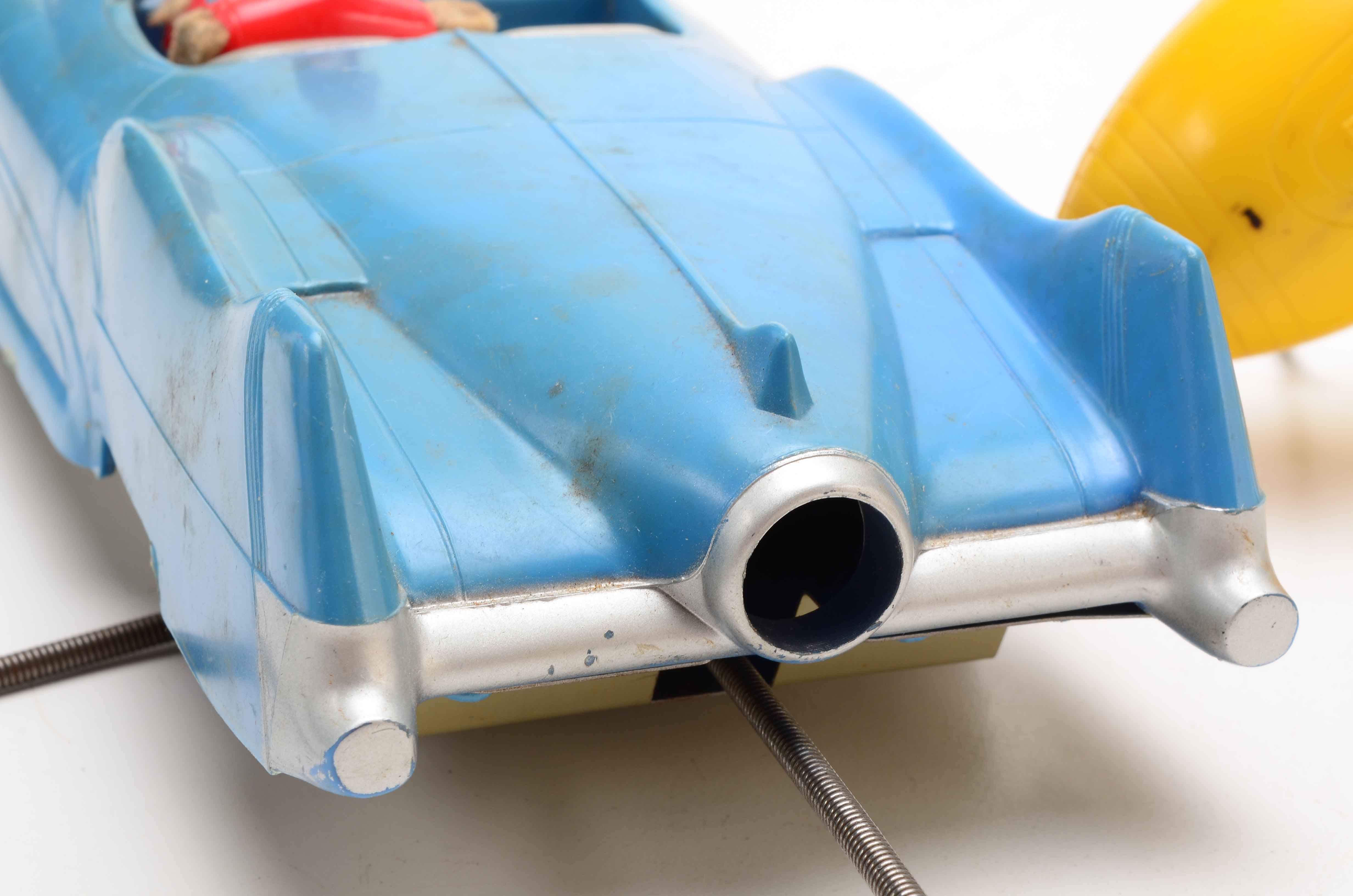 Vintage Blue Car with Yellow Rocket