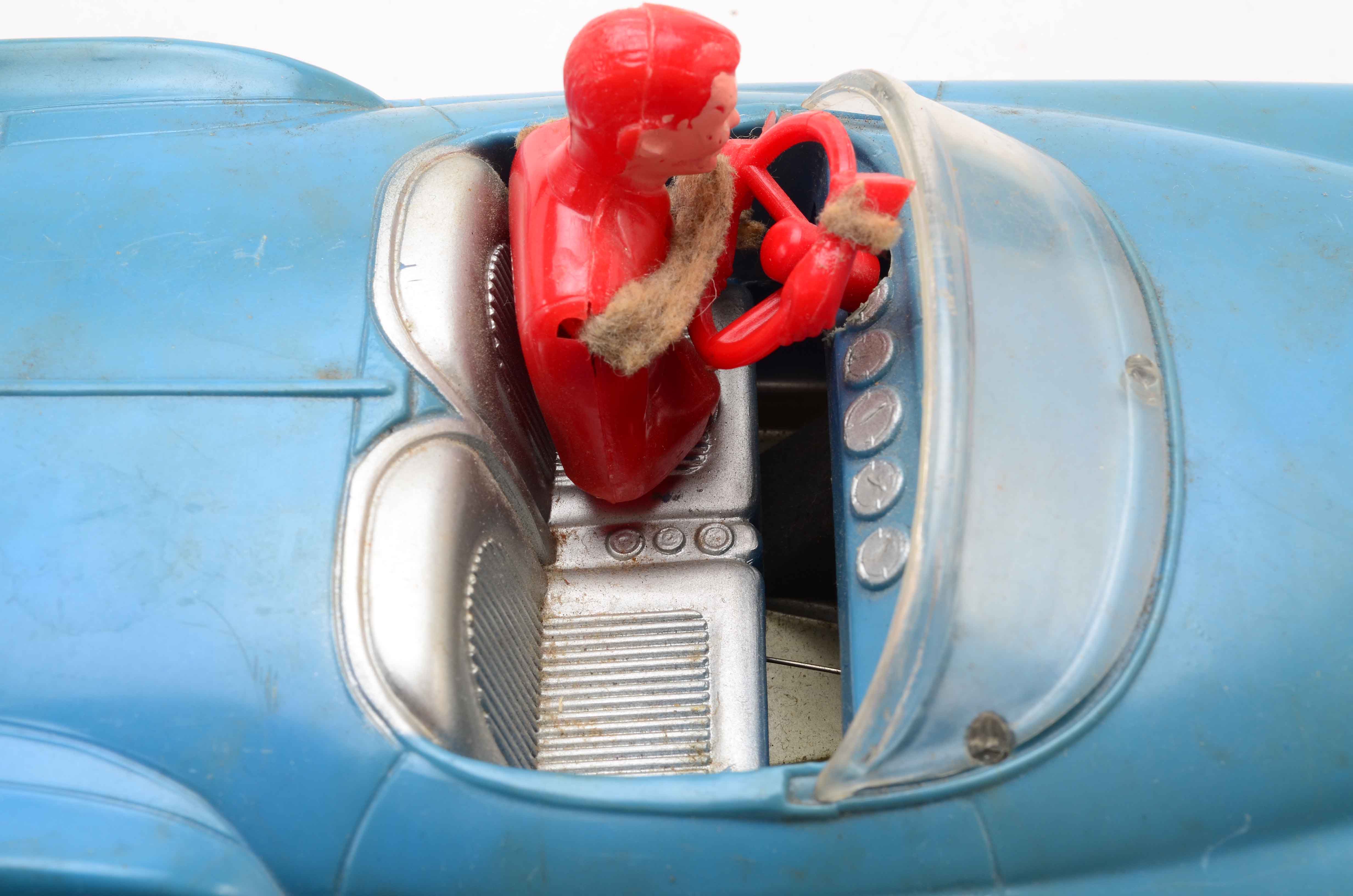 Vintage Blue Car with Yellow Rocket