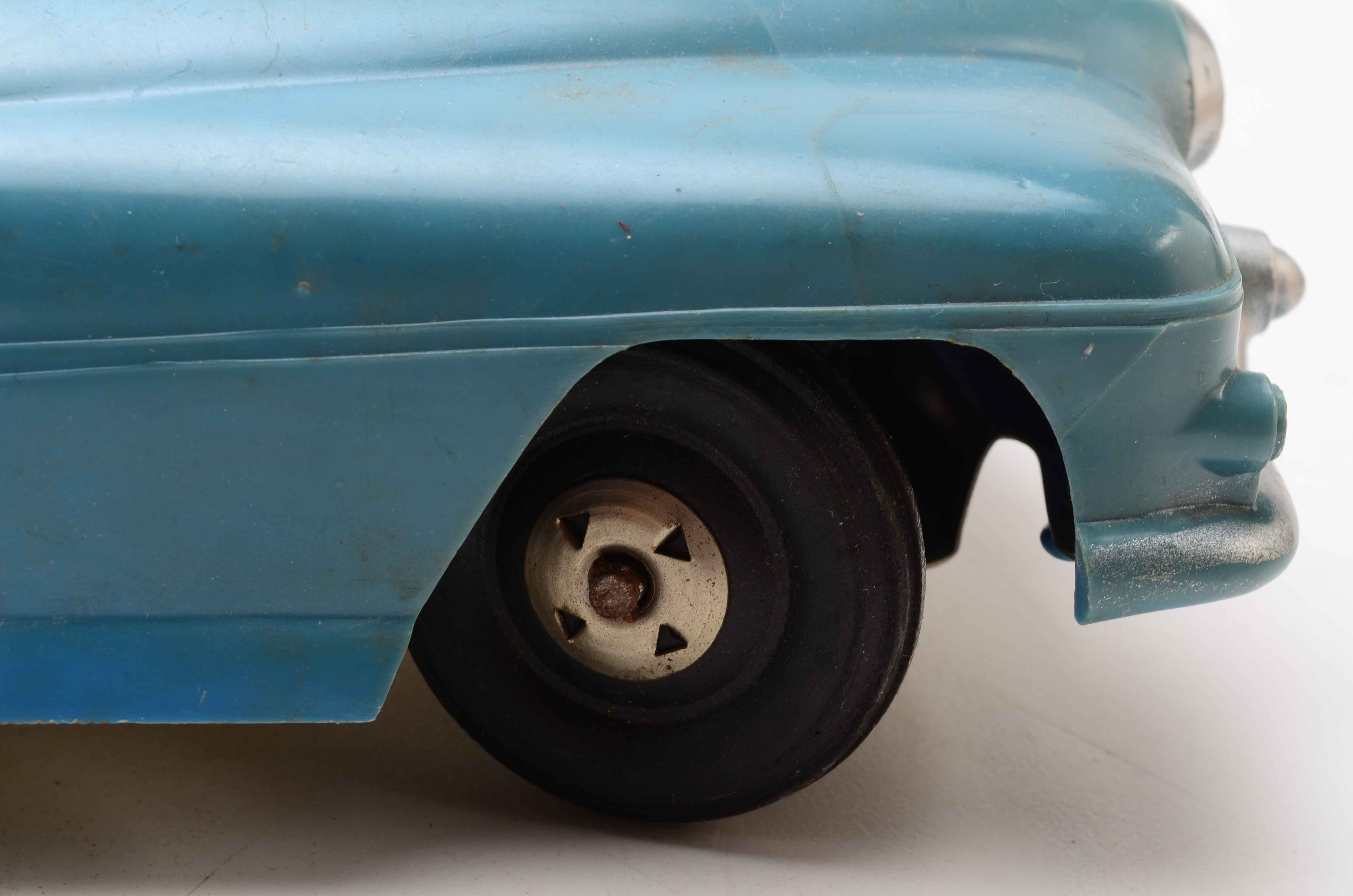 Vintage Blue Car with Yellow Rocket