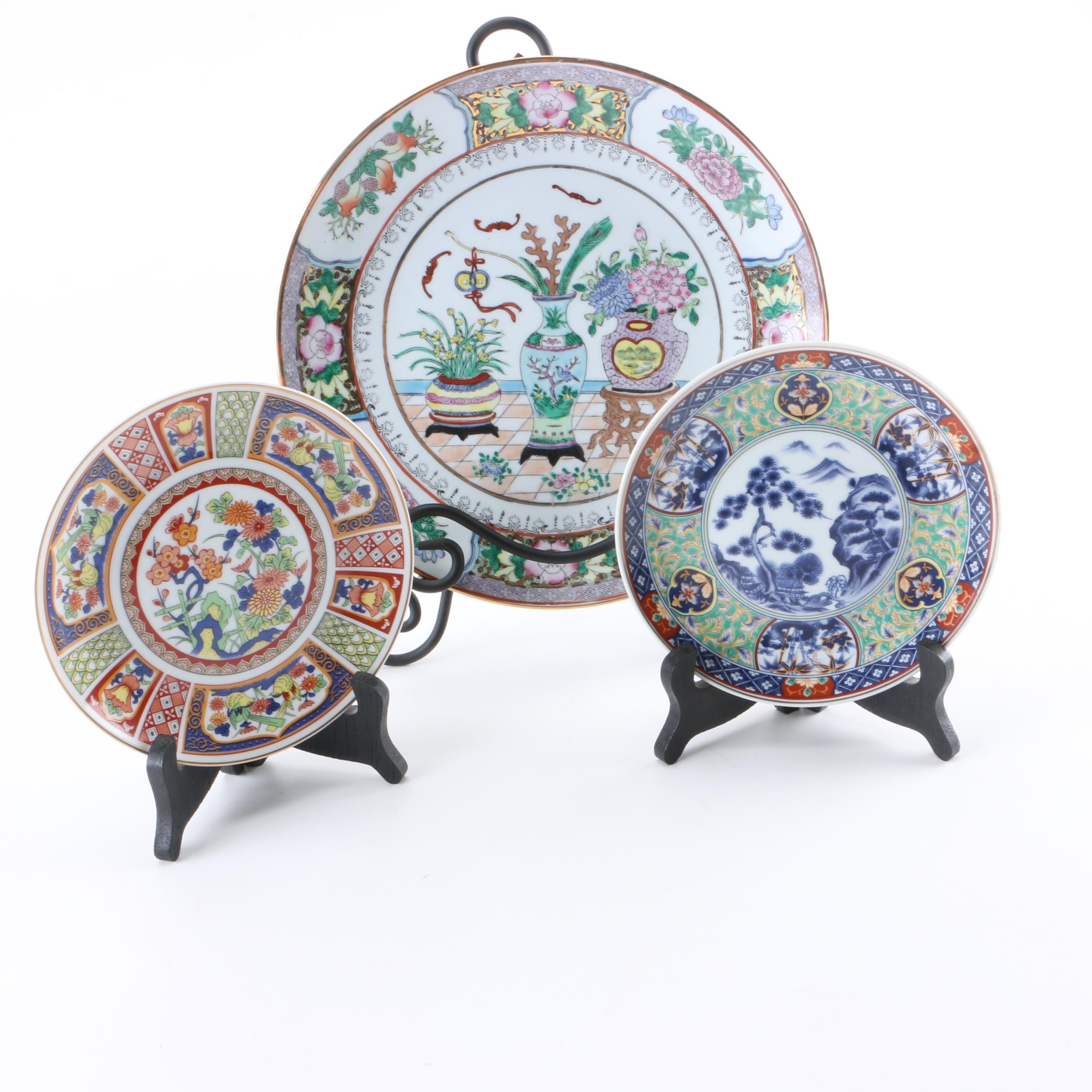 Assortment of Asian Themed Plates and Stands