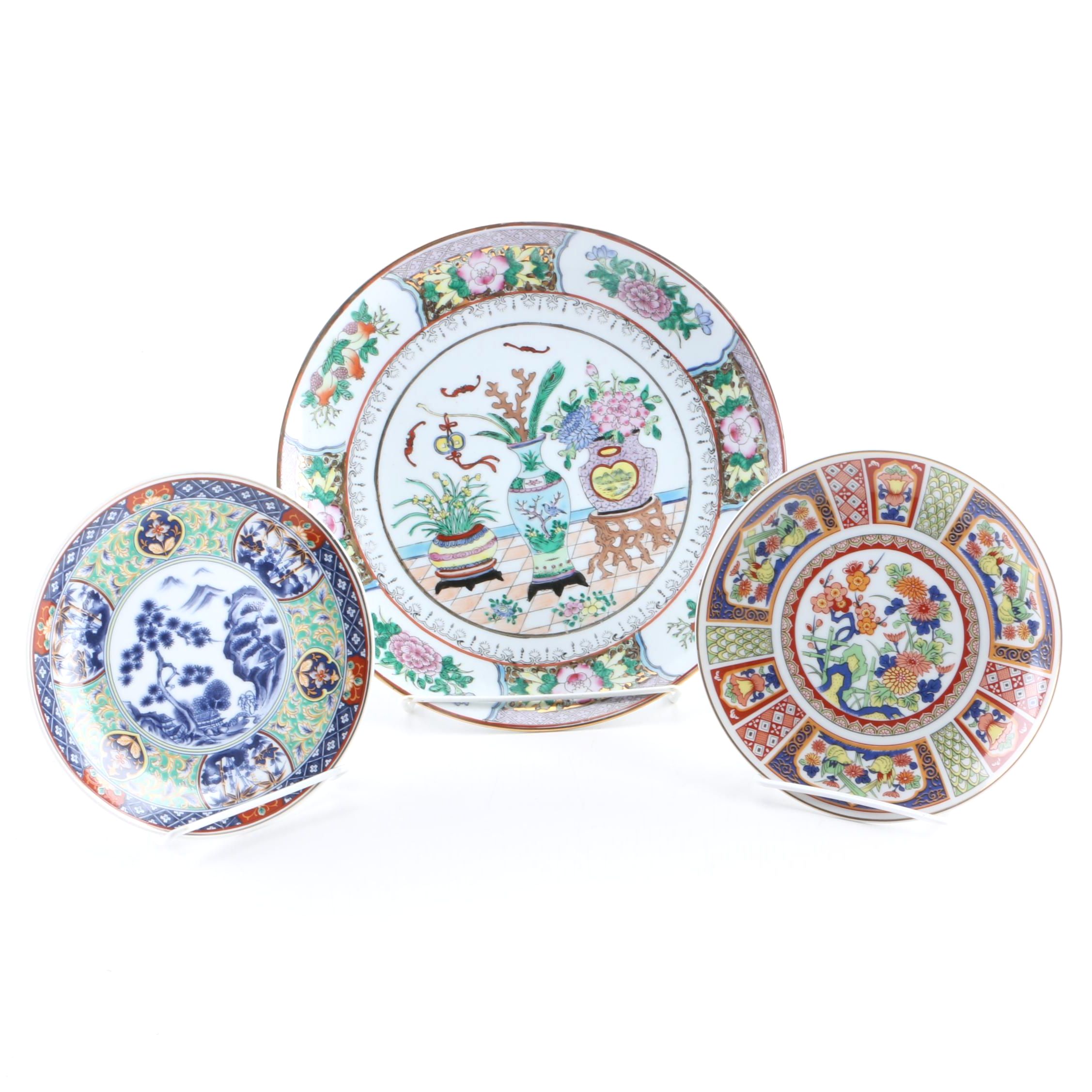 Assortment of Asian Themed Plates and Stands