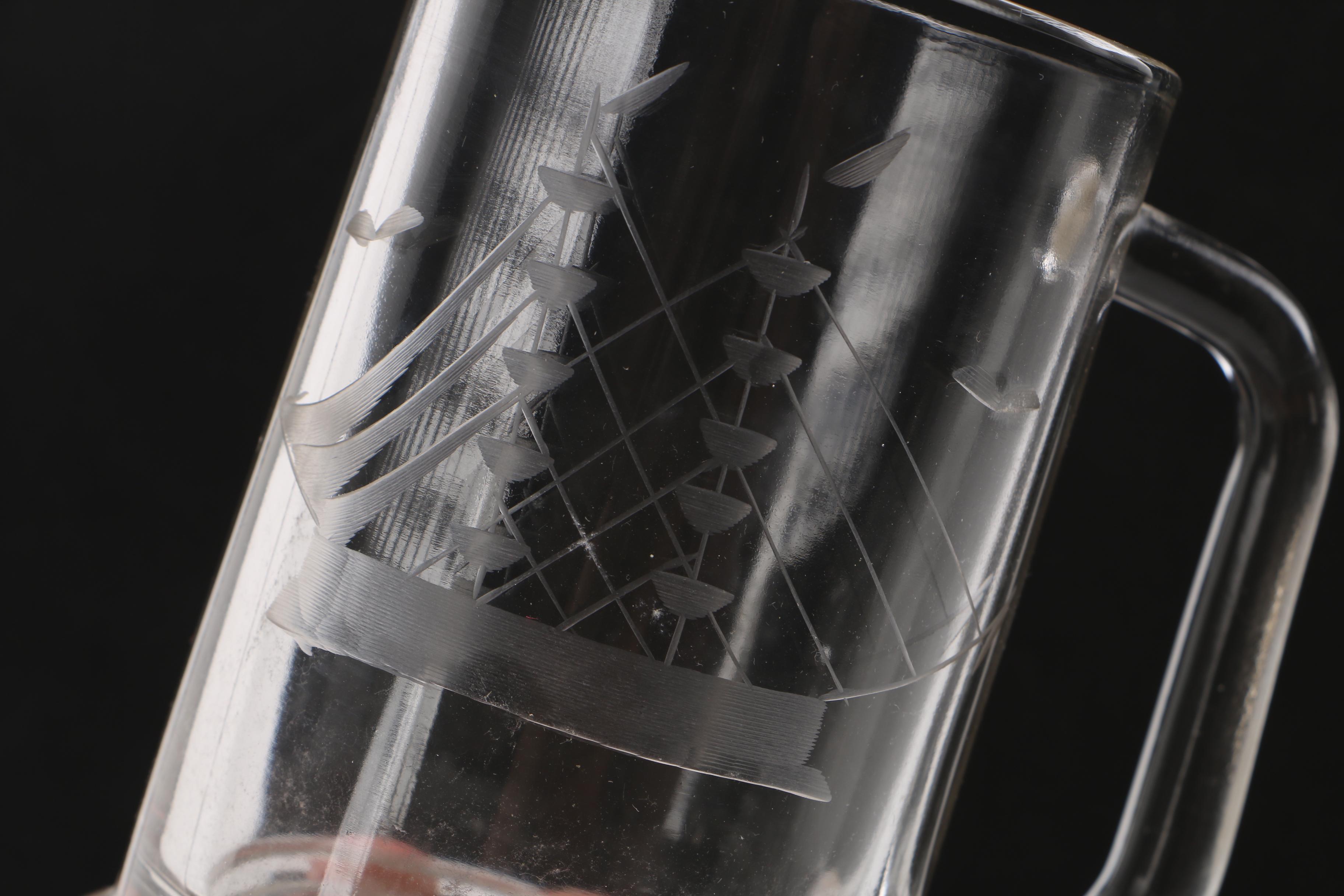 Glass decanter and two beer mugs