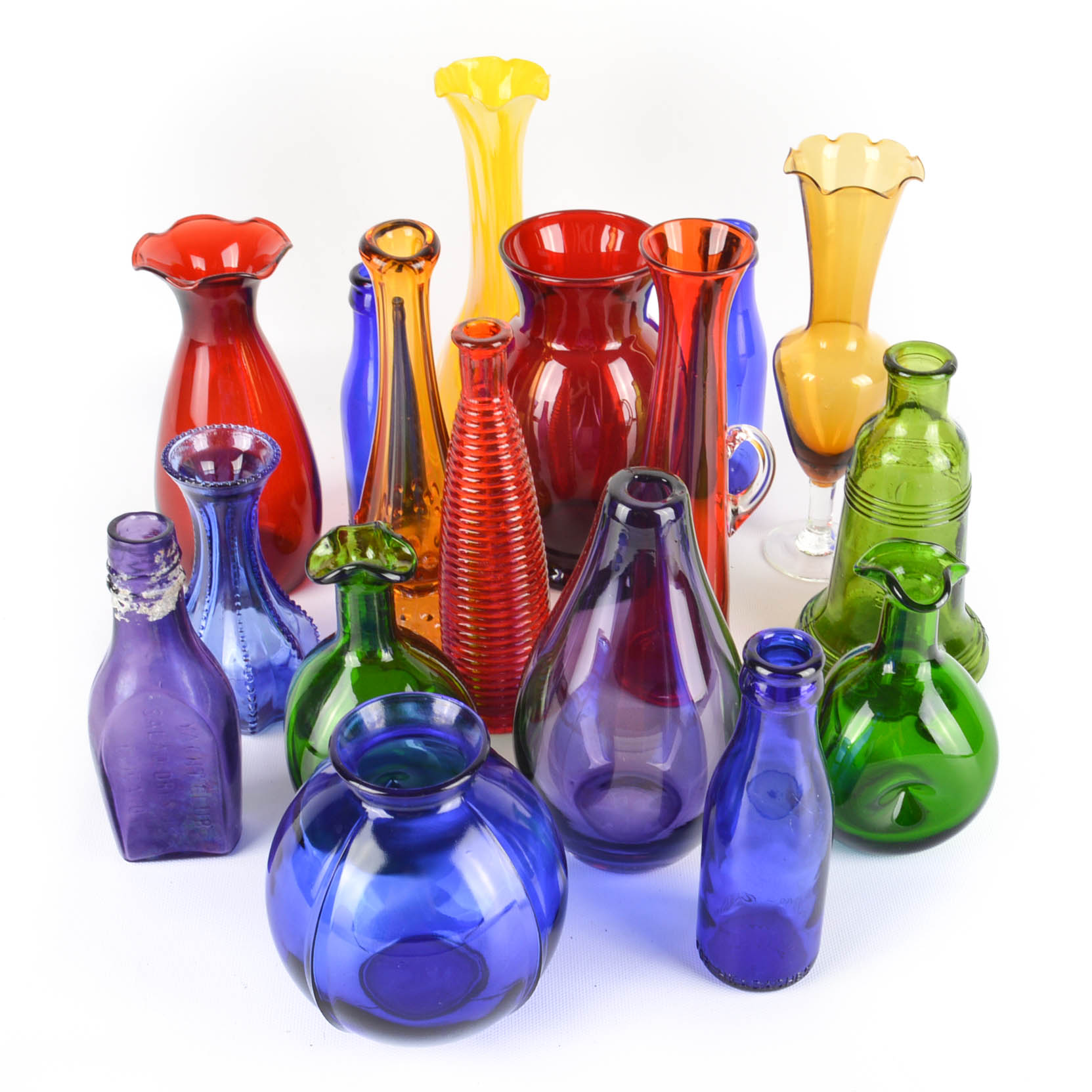 Seventeen Colorful Glass Bottles and Vases