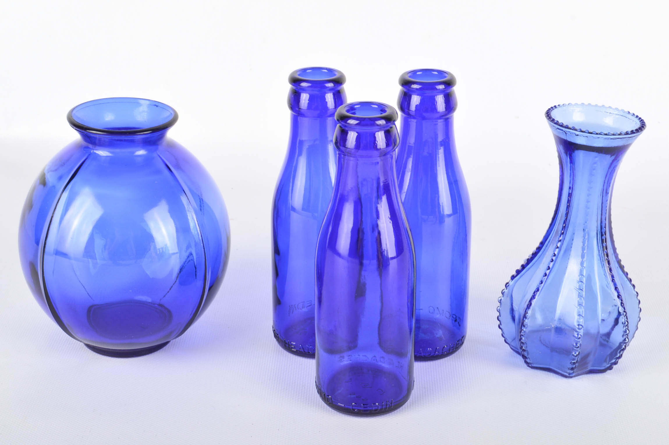 Seventeen Colorful Glass Bottles and Vases
