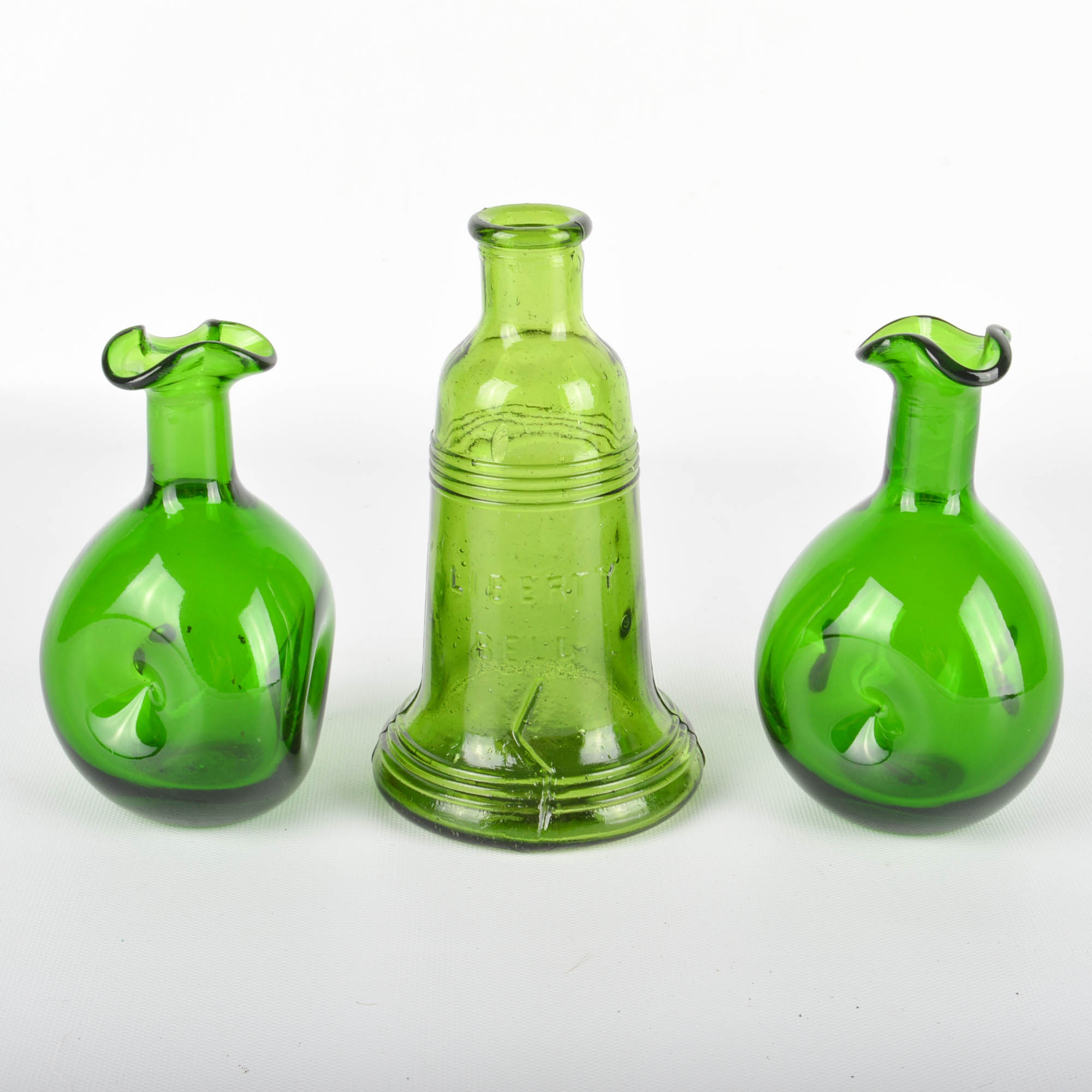 Seventeen Colorful Glass Bottles and Vases