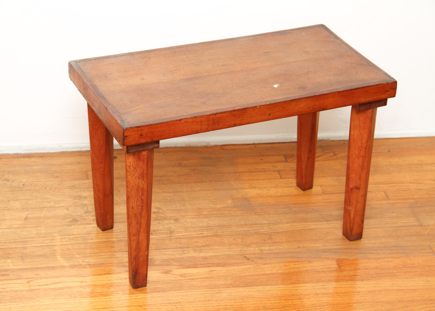 Three Wooden Stools and a Wastebasket