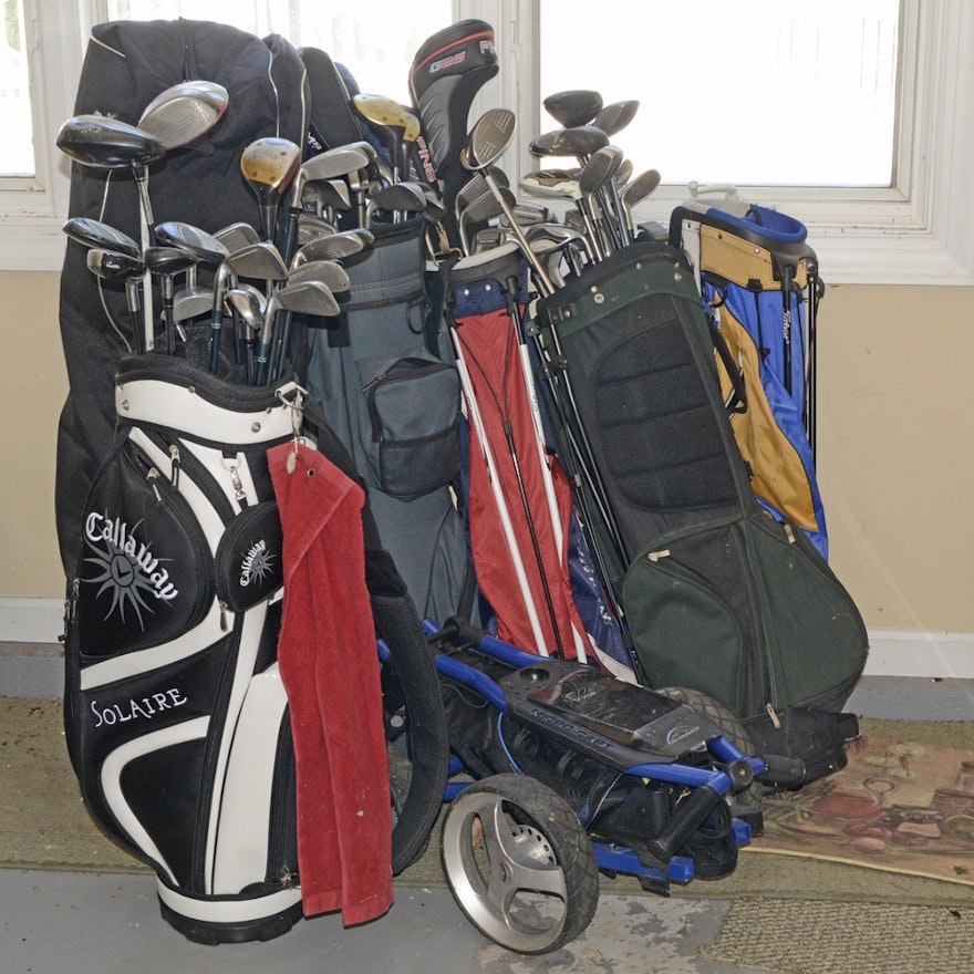 Assortment of Golf Bags with Clubs Including Sun Mountain Cart