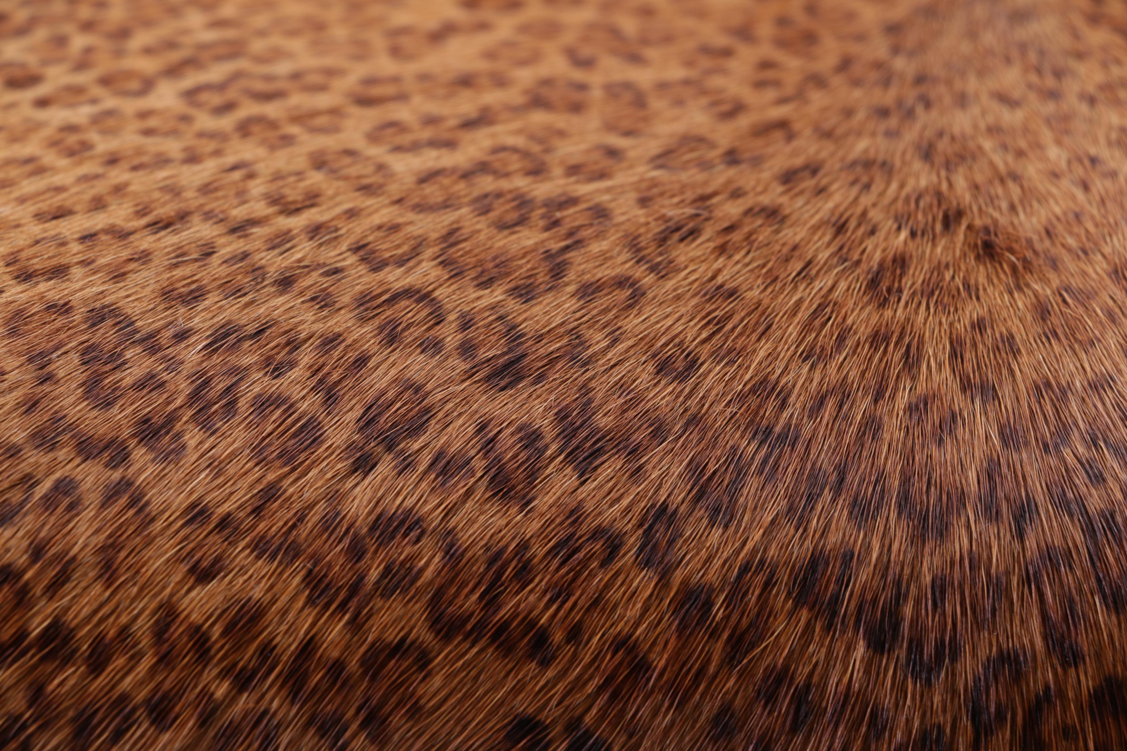 Upholstered Leopard Print Ottoman