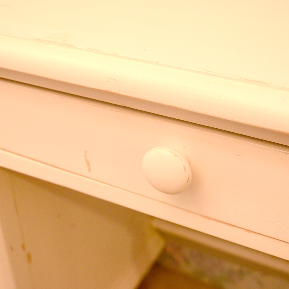 white wooden single pedestal desk