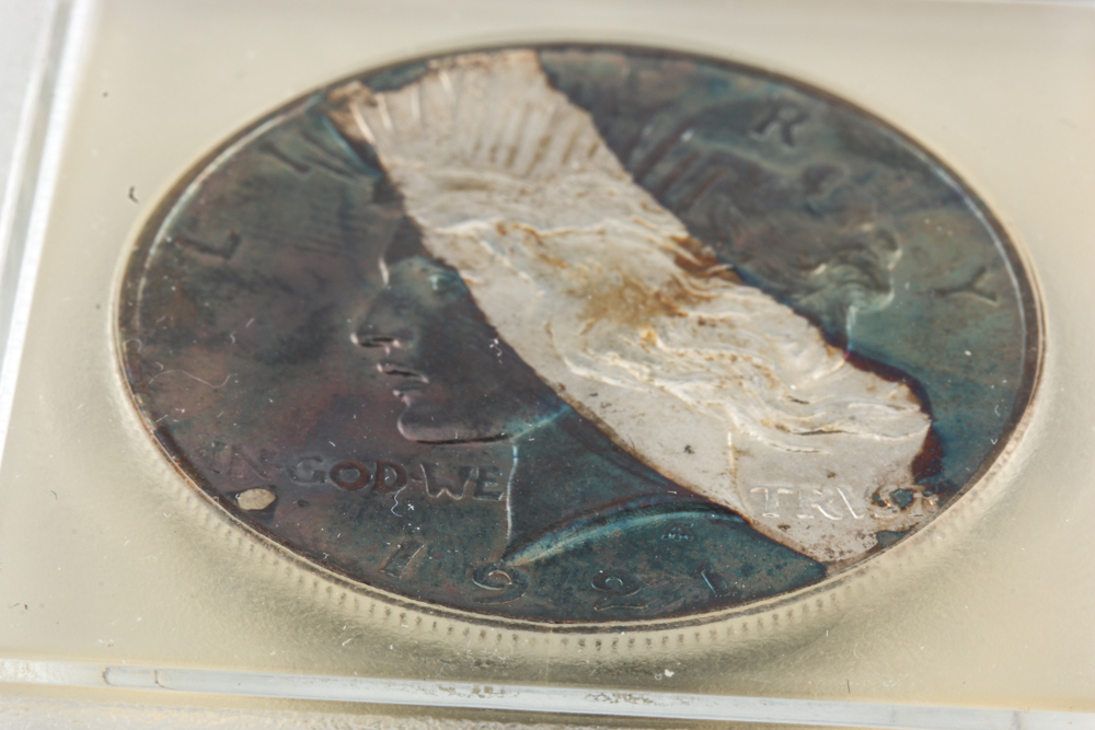 Encapsulated 1921 Peace Silver Dollar with Rainbow Toning