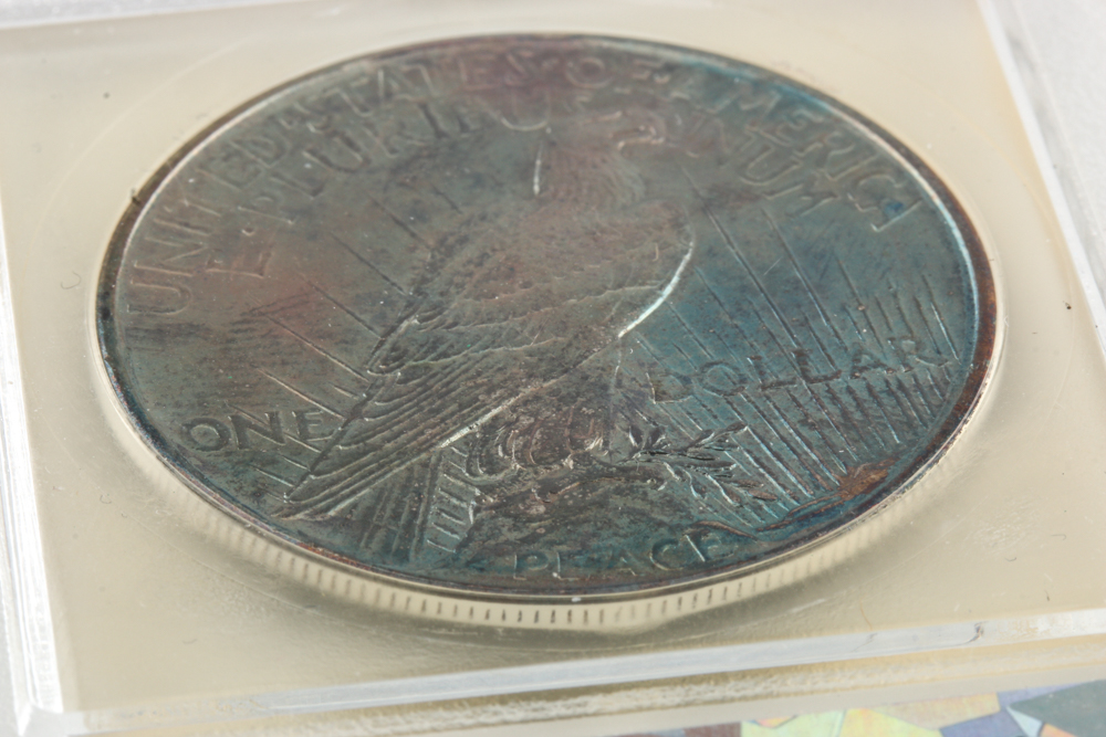 Encapsulated 1921 Peace Silver Dollar with Rainbow Toning