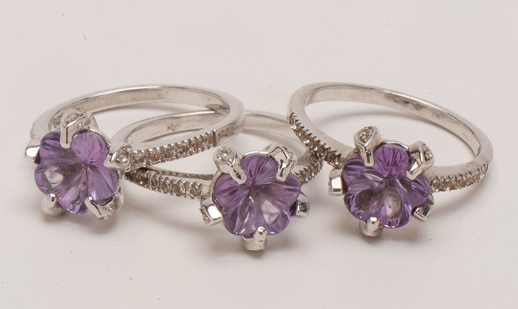 Four Sterling Amethyst Rings with Diamond and Topaz Accents