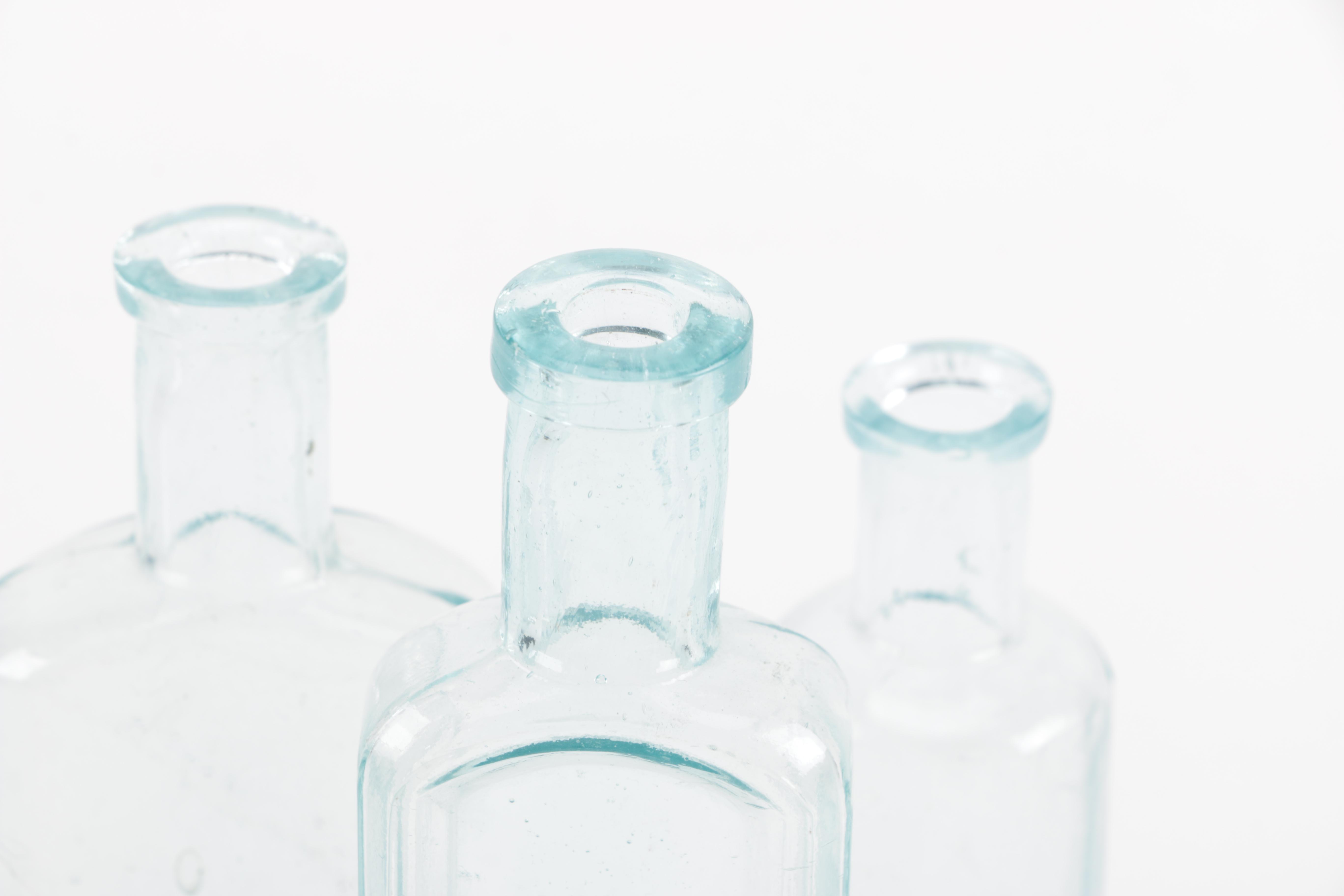 Glass Vase and Bottles Featuring Whitall & Tatum Co.