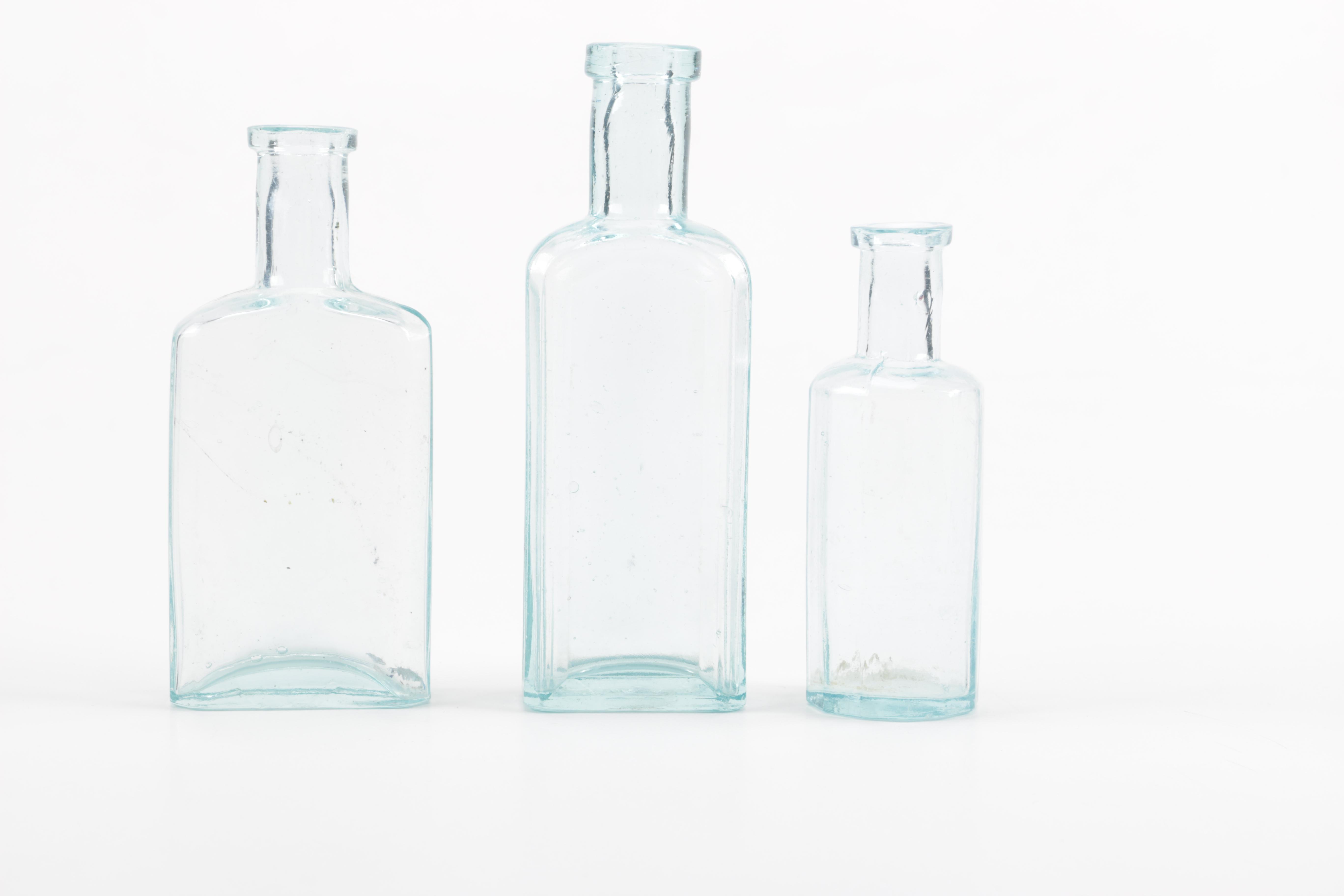 Glass Vase and Bottles Featuring Whitall & Tatum Co.