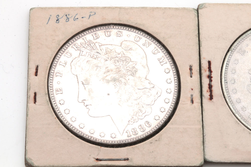 Group of Five Silver Morgan Dollars Including the Following: 1884, 1886, and three 1921