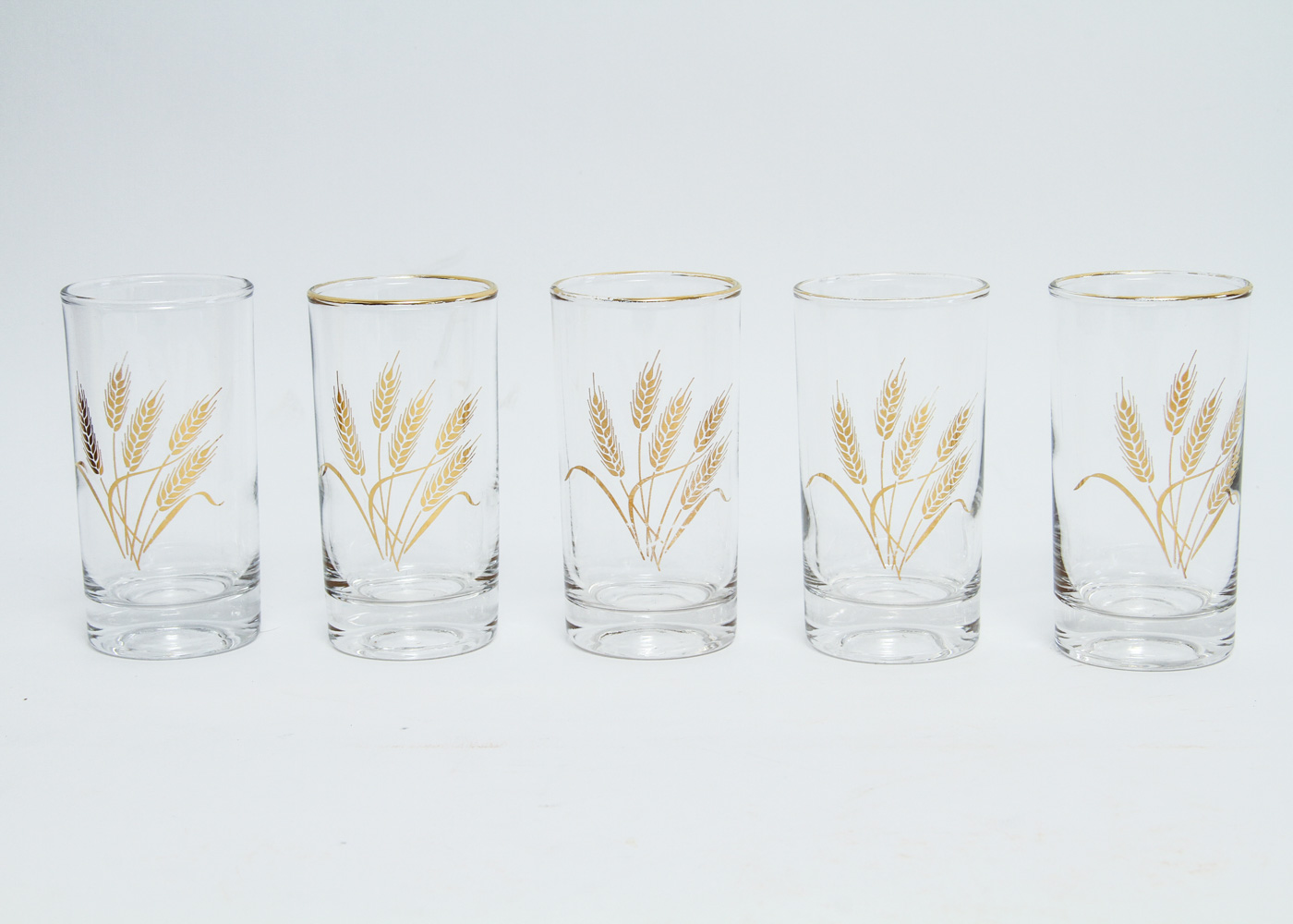 Collection of Eleven Mid-Century Drinking Glasses with a Gold Tone Wheat Motif