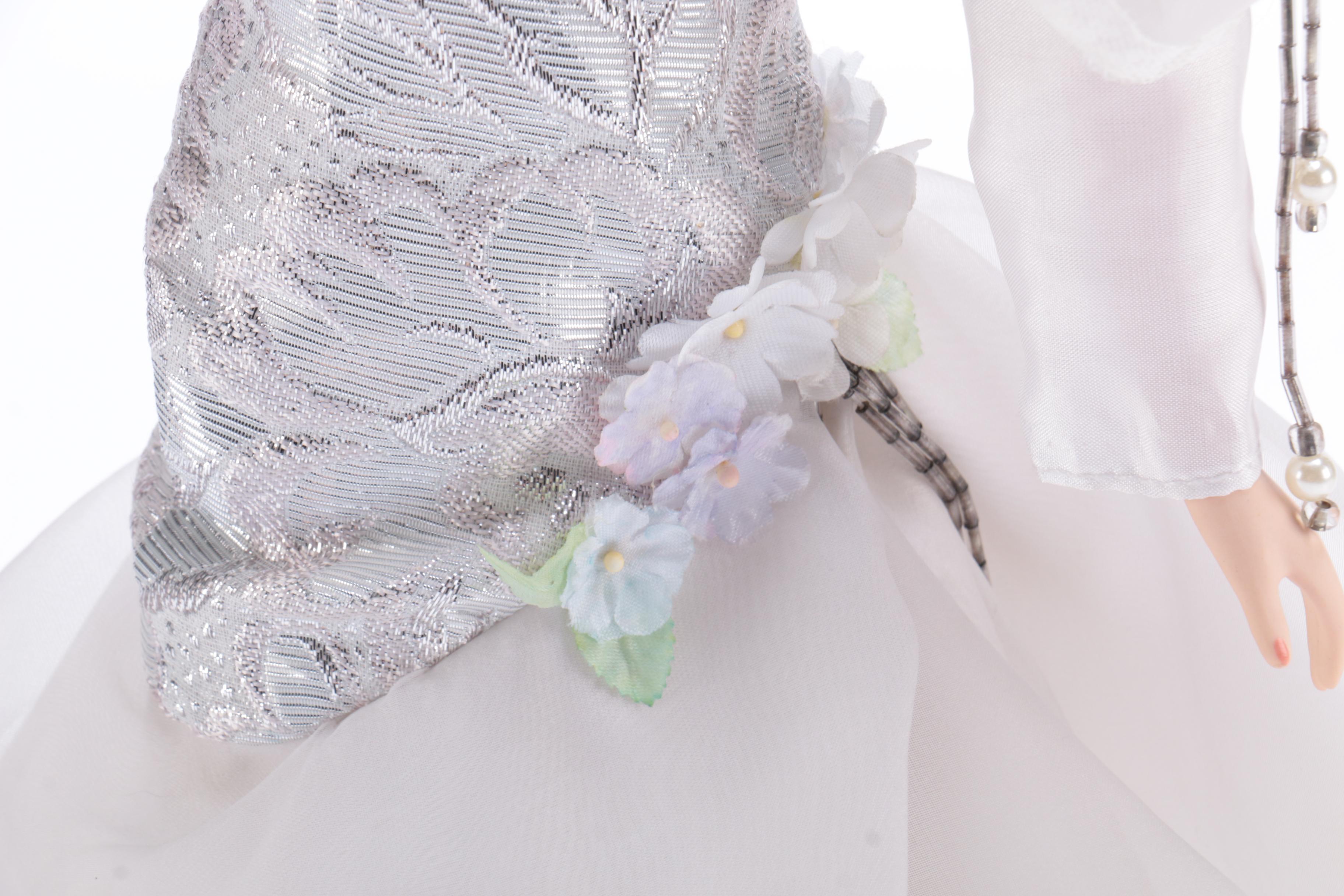 Porcelain Doll in a White Dress