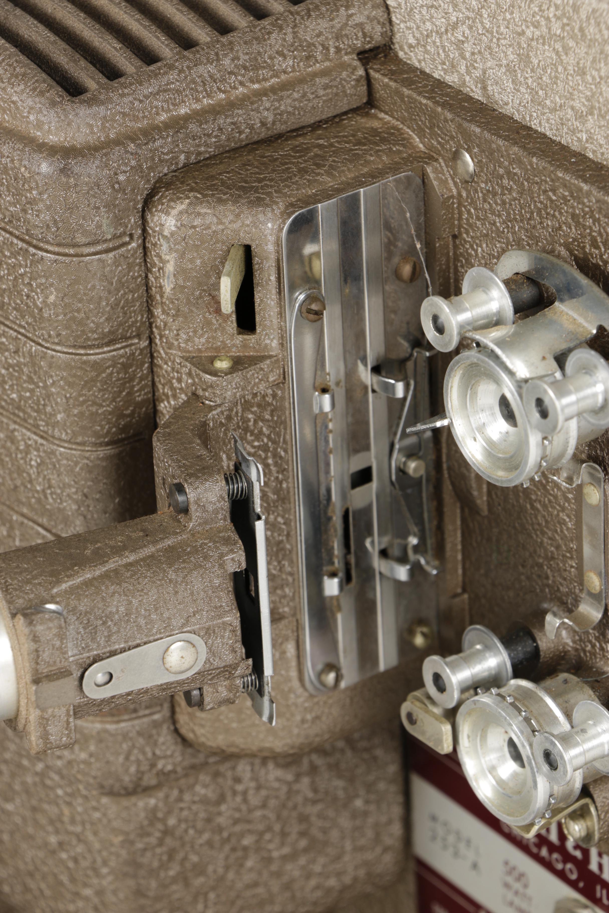 Four Vintage Projectors with Carrying Cases including Bell & Howell