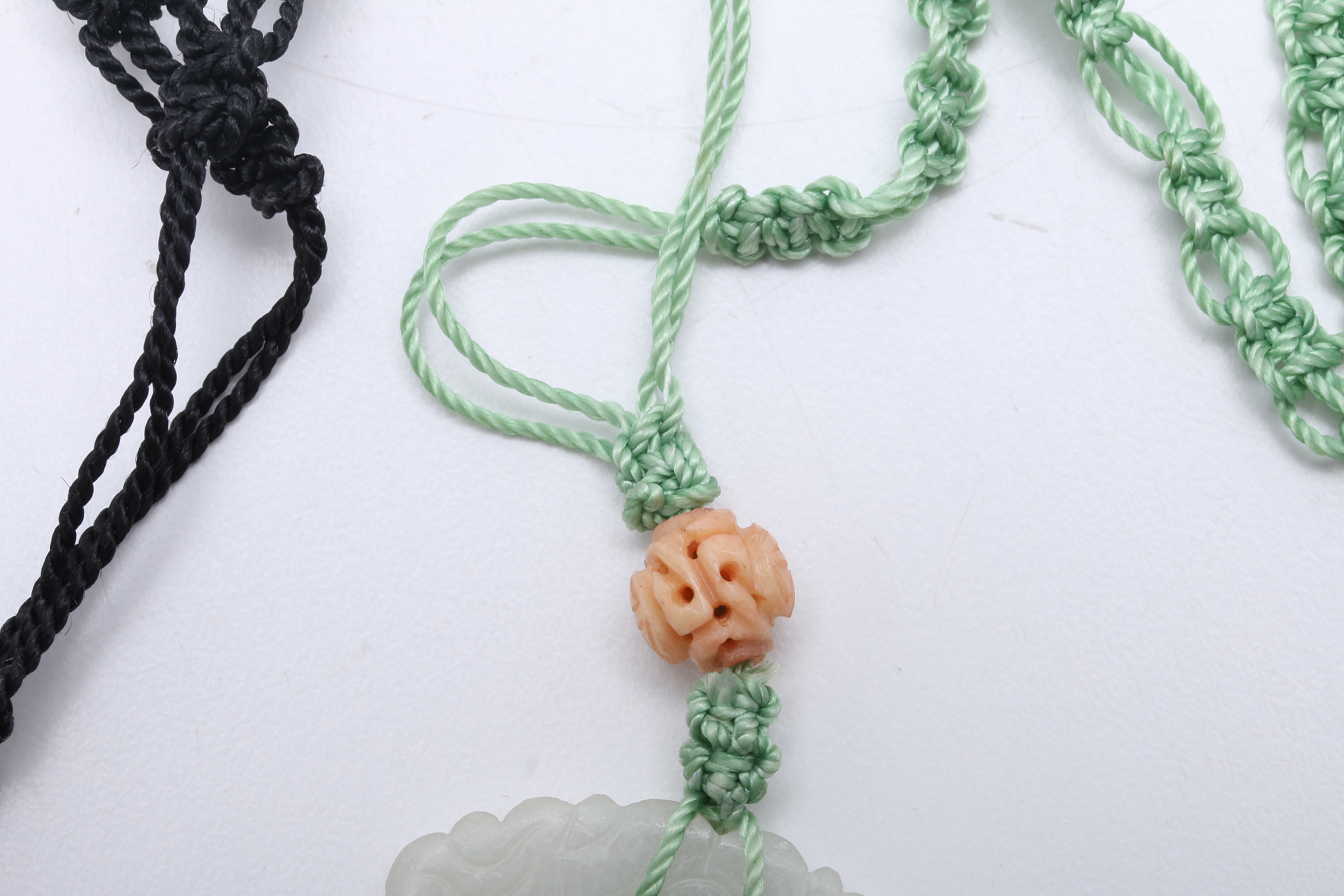 Two Carved Pendants on Knotted Silk Cords, Smoky Quartz & Jadeite
