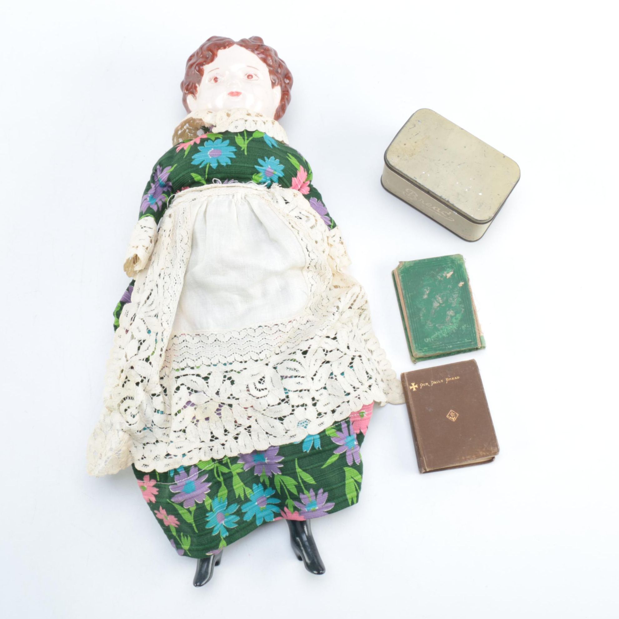 Porcelain Doll with Religious Books and Tin Container