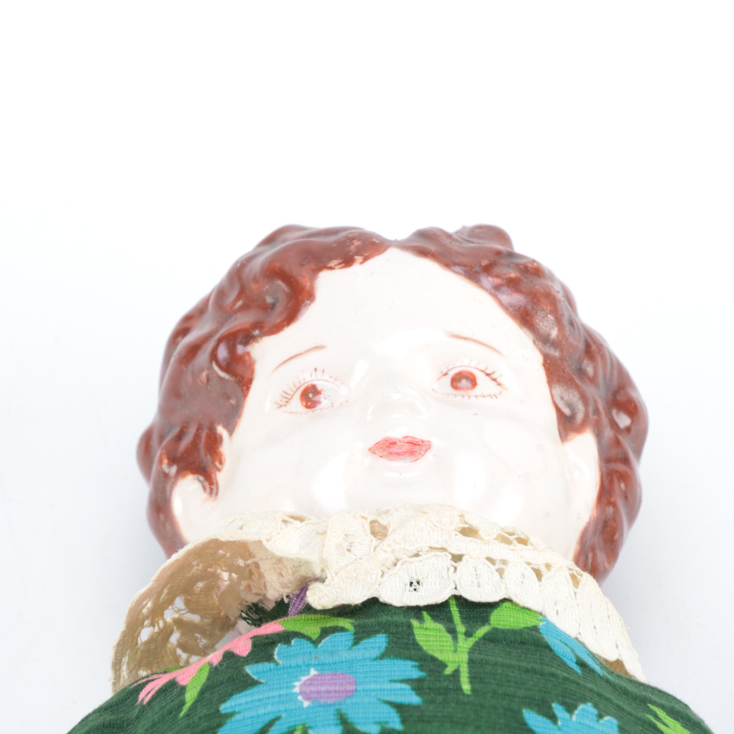 Porcelain Doll with Religious Books and Tin Container