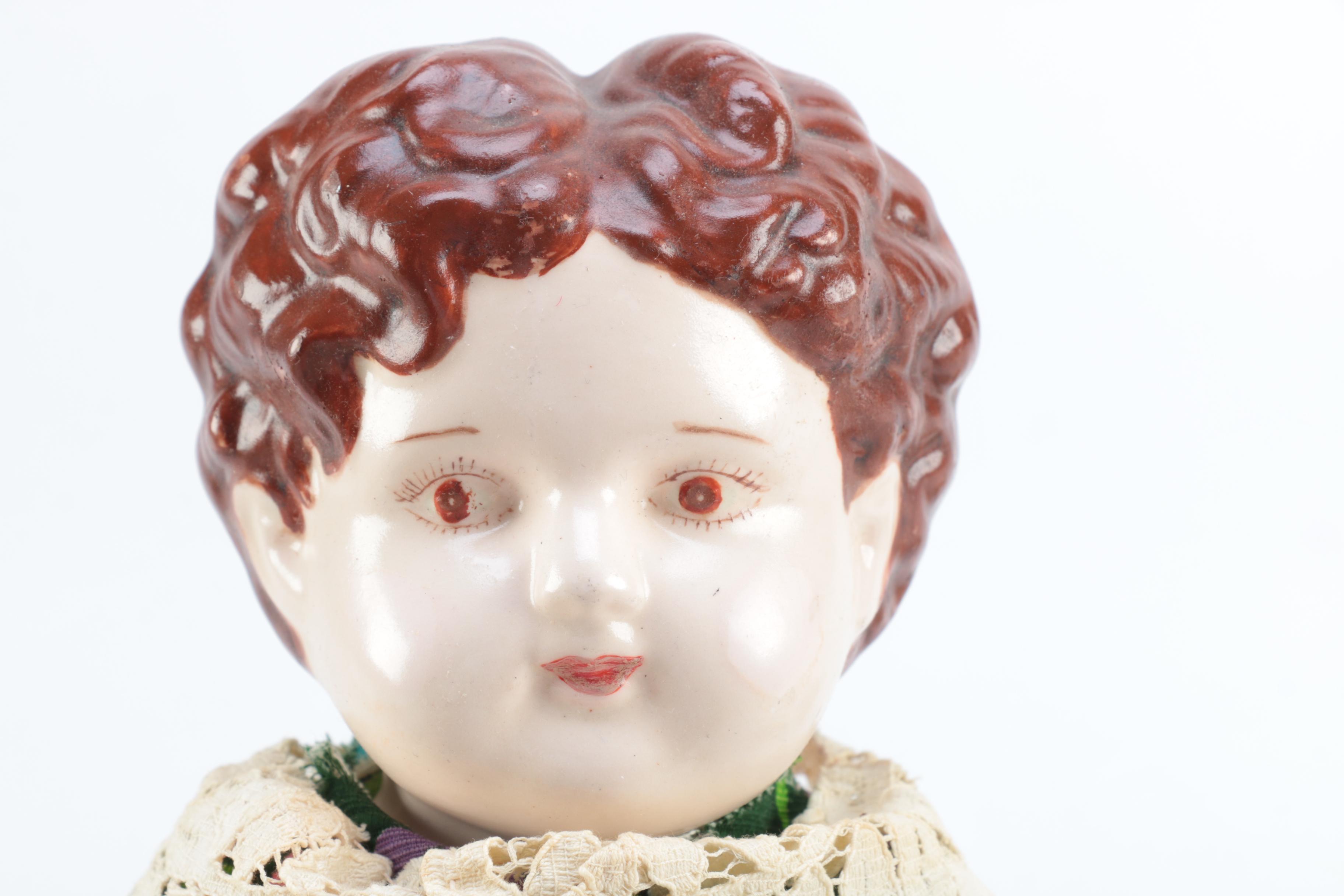 Porcelain Doll with Religious Books and Tin Container