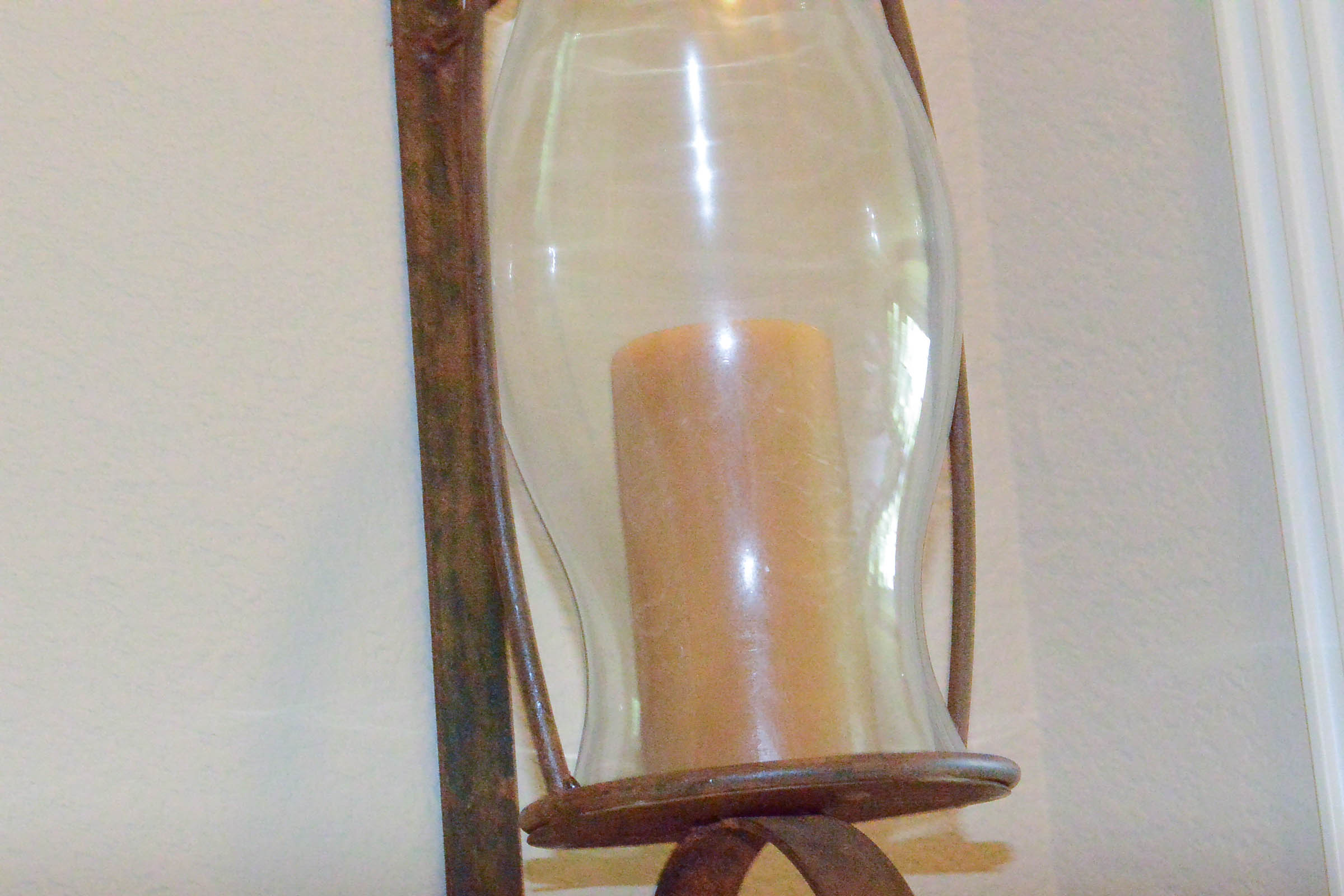 Pair of Large Wrought Metal and Glass Wall Sconces