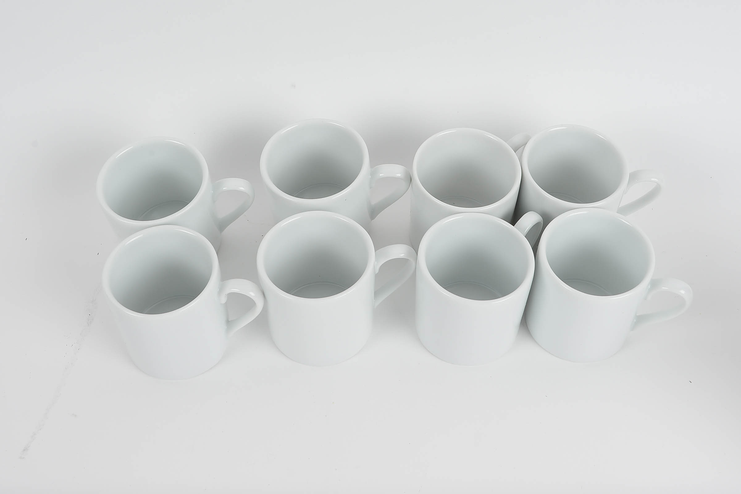 Set of Eight White Glazed Demitasse Cups and Saucers