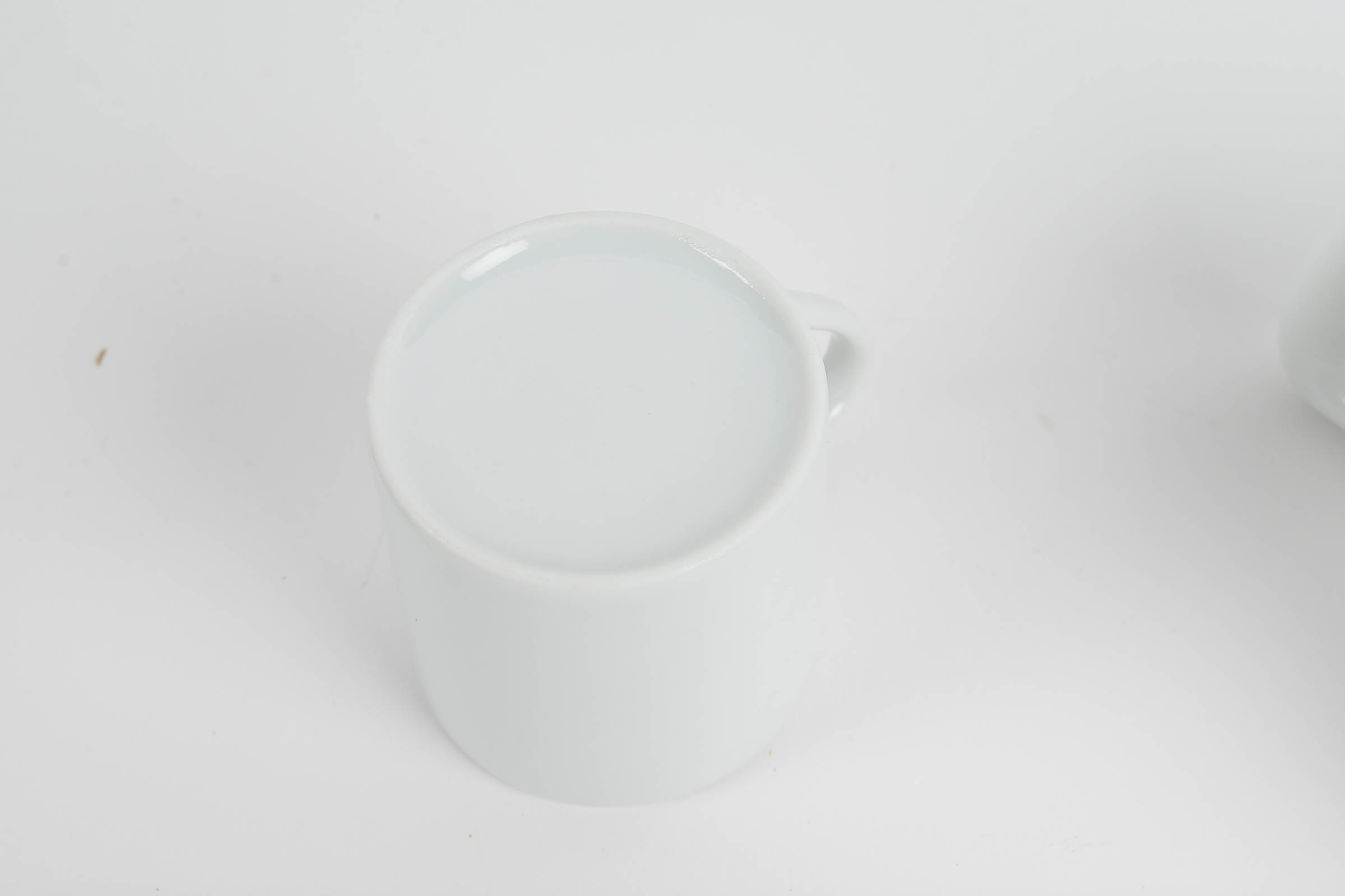 Set of Eight White Glazed Demitasse Cups and Saucers