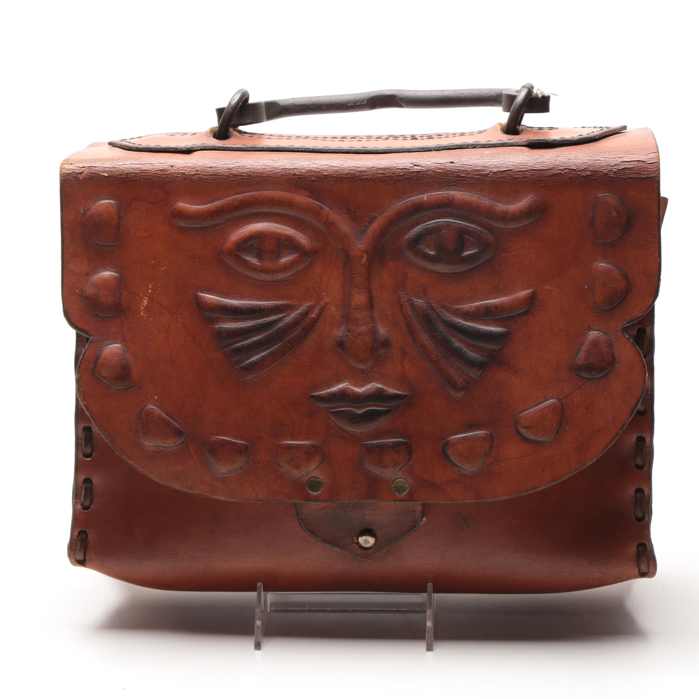 Leather Handbag with Embossed Face and Wrought Iron Handle
