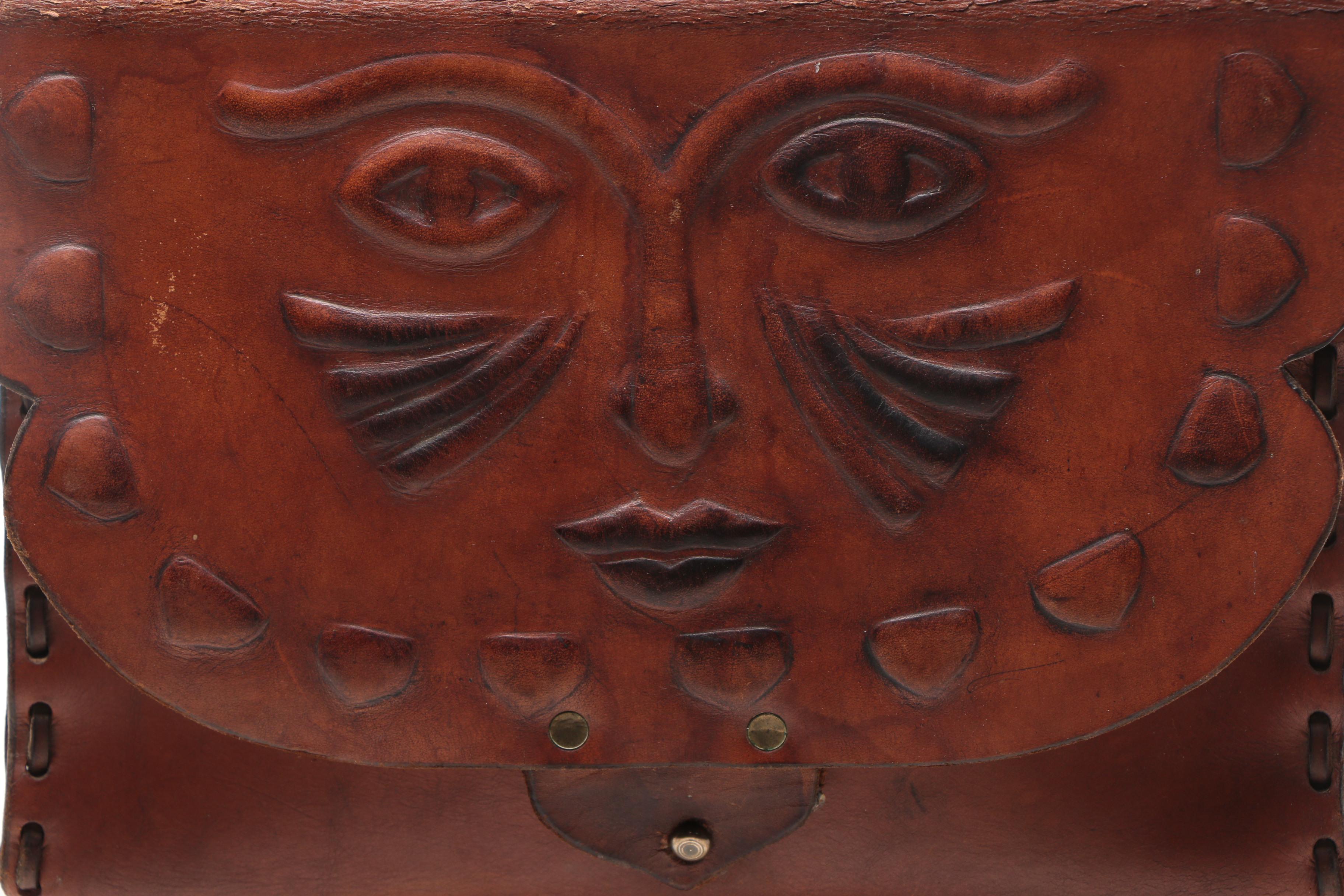 Leather Handbag with Embossed Face and Wrought Iron Handle