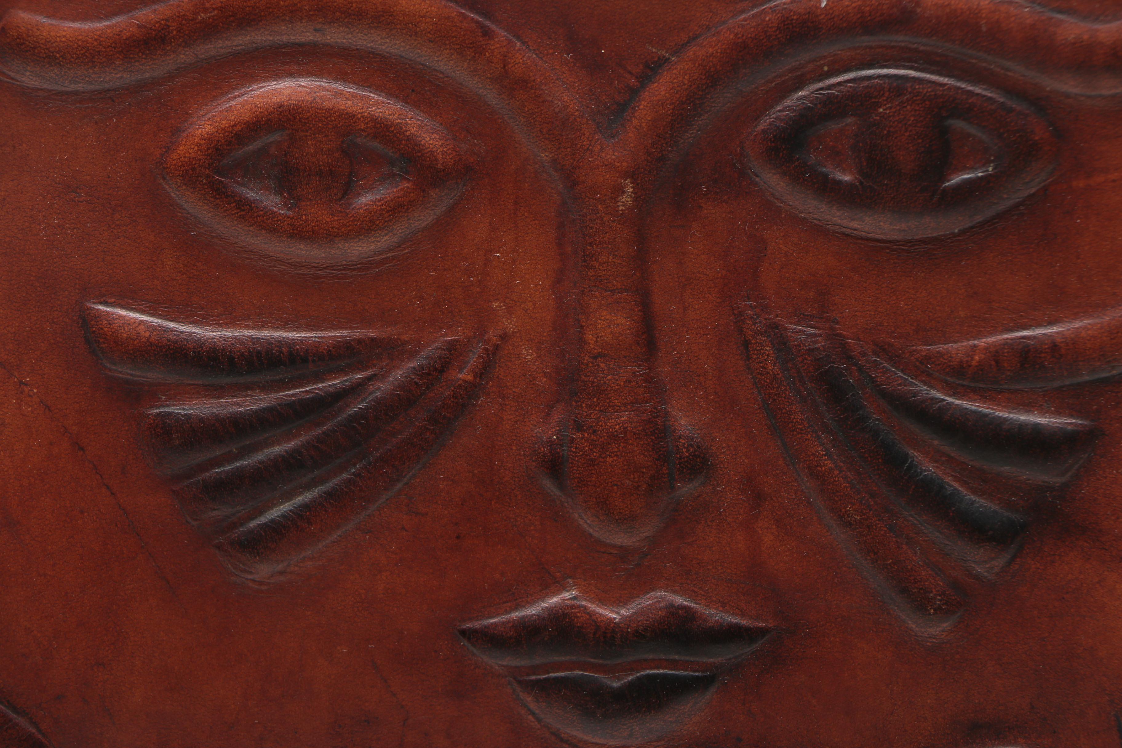 Leather Handbag with Embossed Face and Wrought Iron Handle