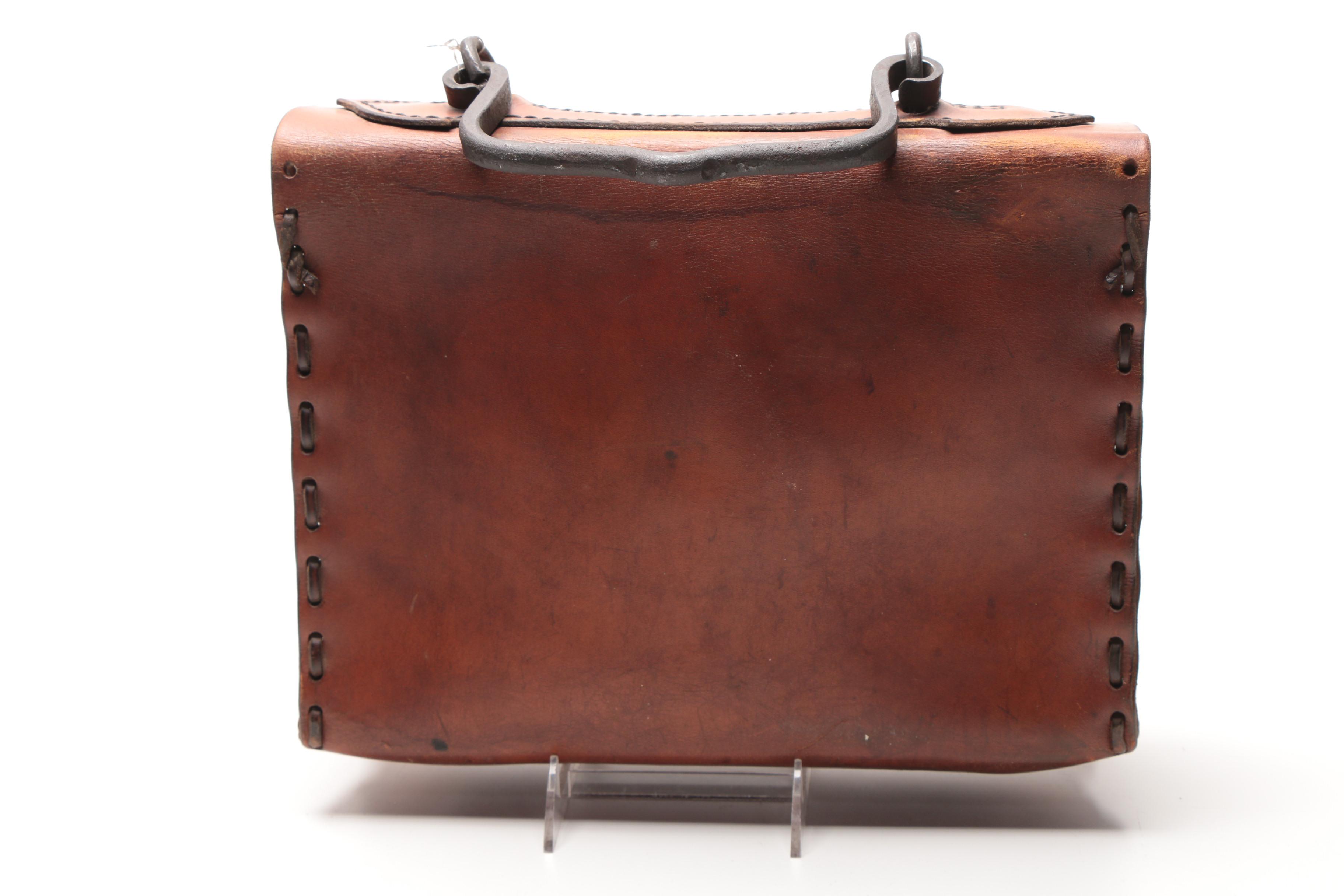 Leather Handbag with Embossed Face and Wrought Iron Handle