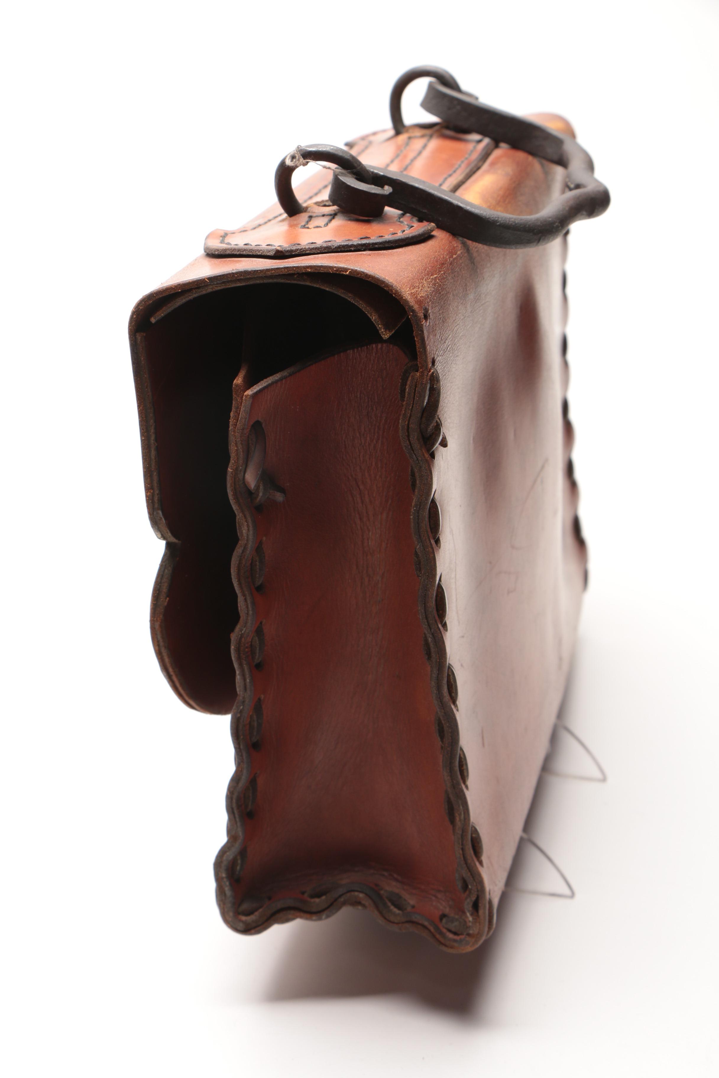 Leather Handbag with Embossed Face and Wrought Iron Handle