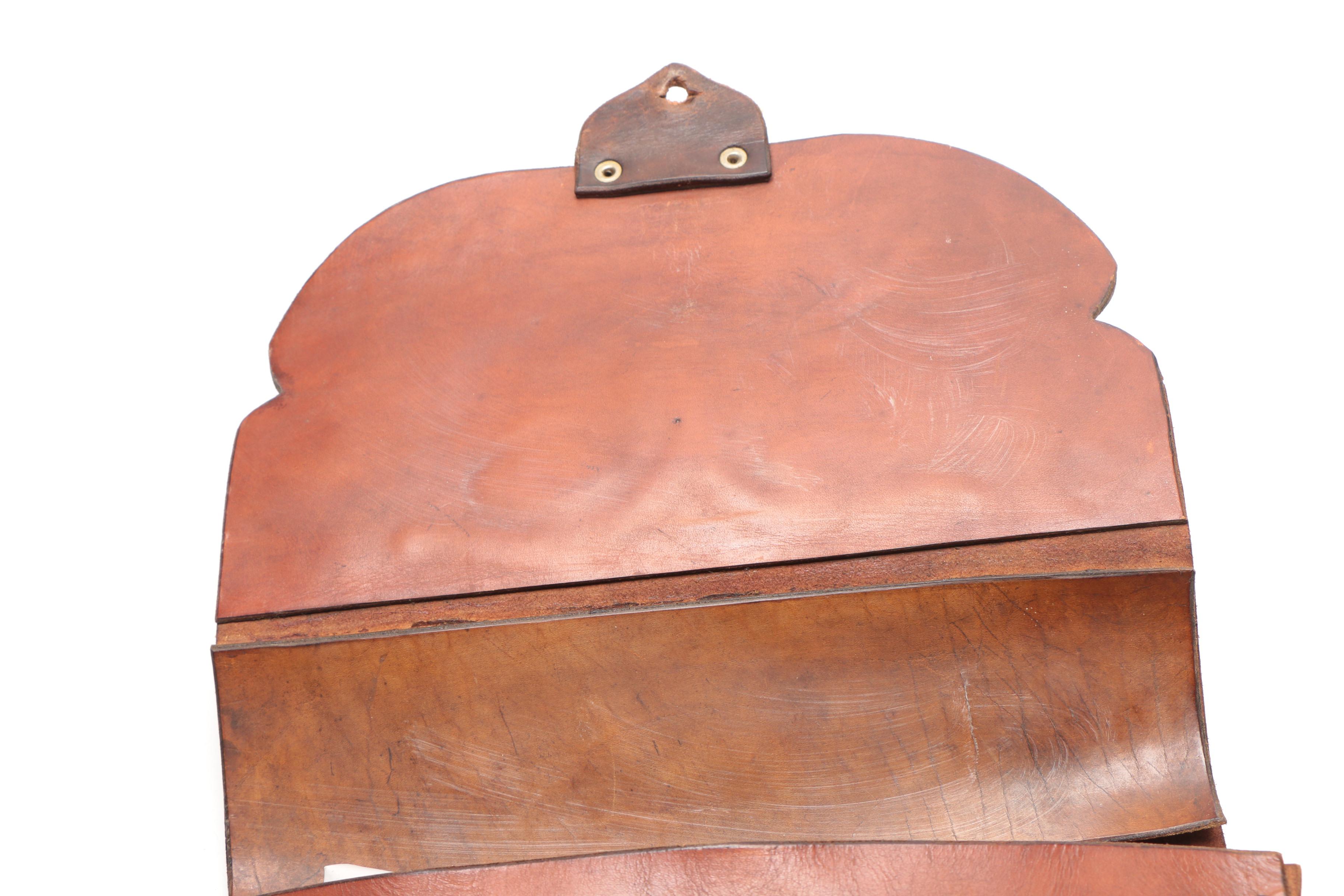 Leather Handbag with Embossed Face and Wrought Iron Handle