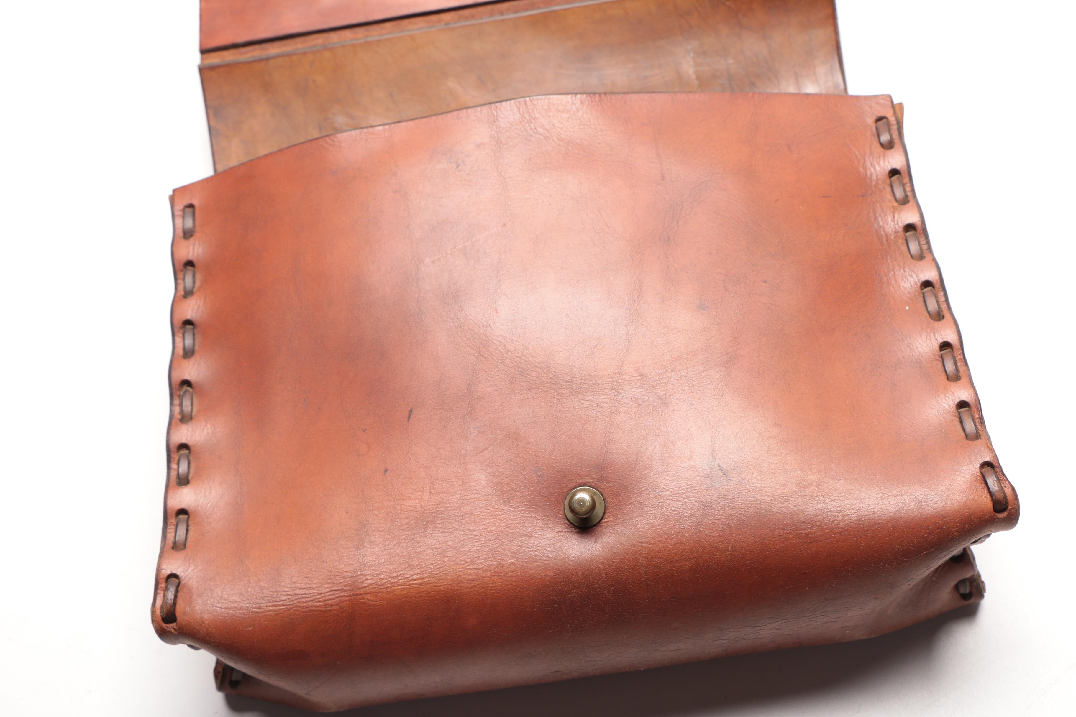 Leather Handbag with Embossed Face and Wrought Iron Handle