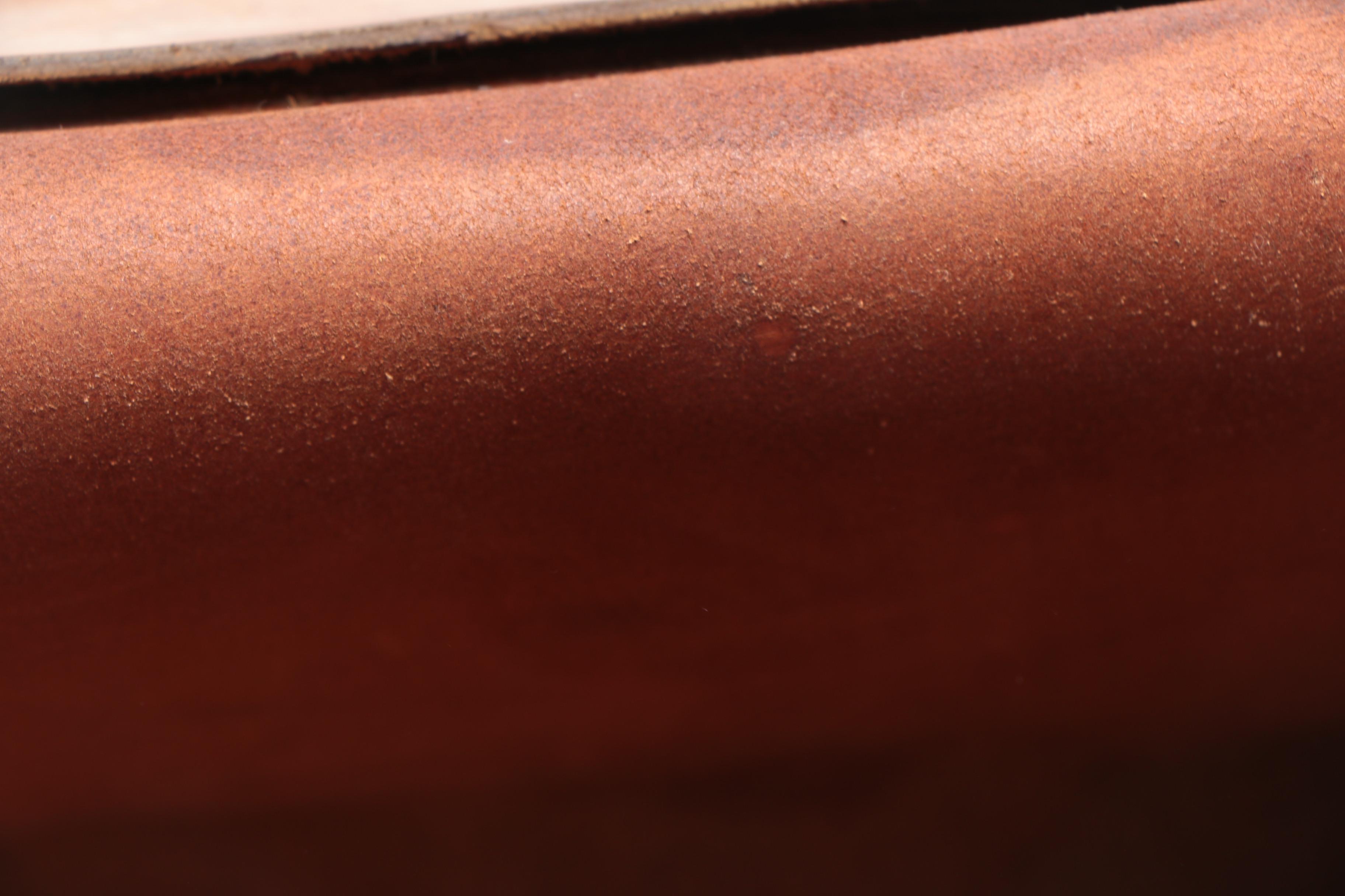 Leather Handbag with Embossed Face and Wrought Iron Handle