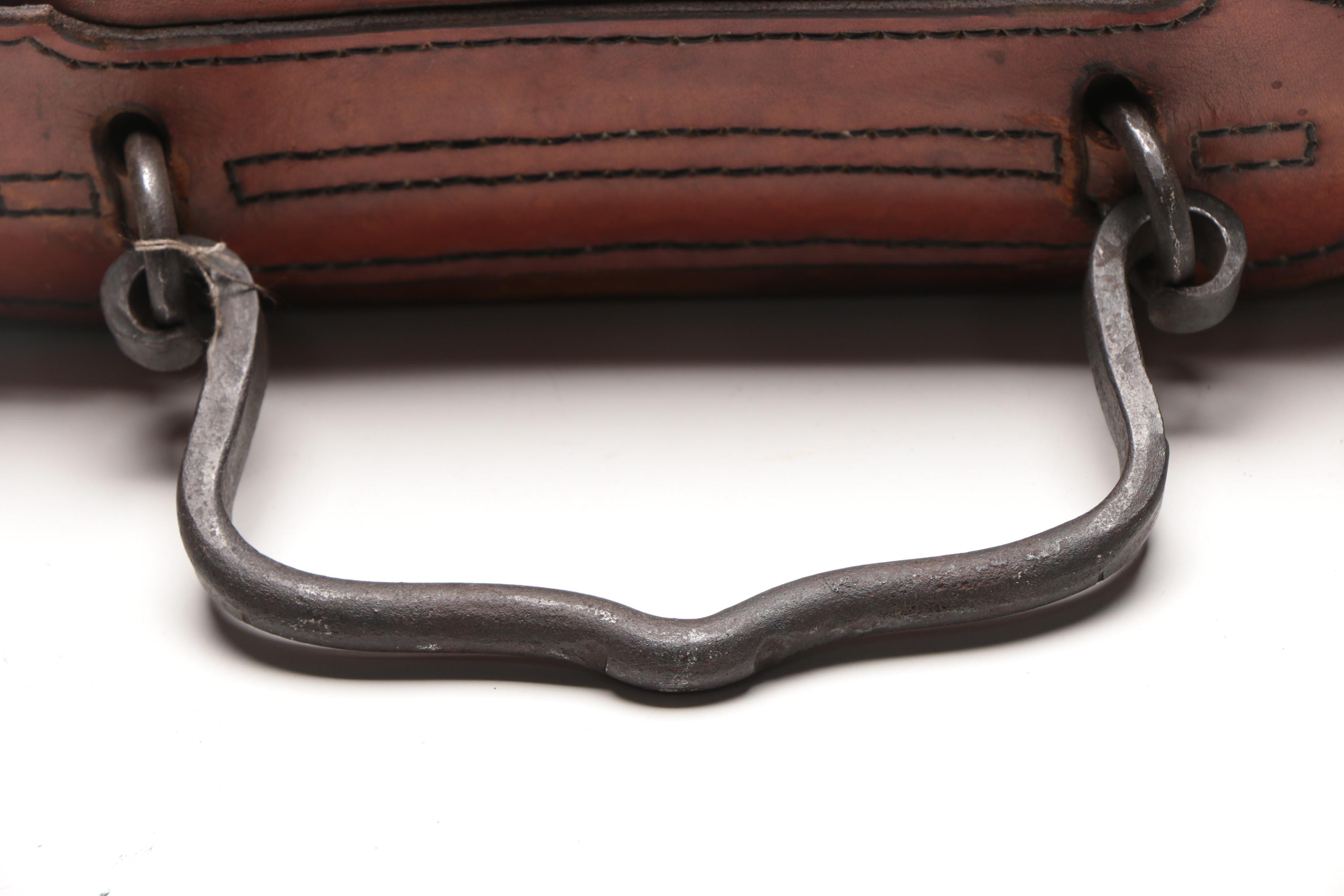 Leather Handbag with Embossed Face and Wrought Iron Handle