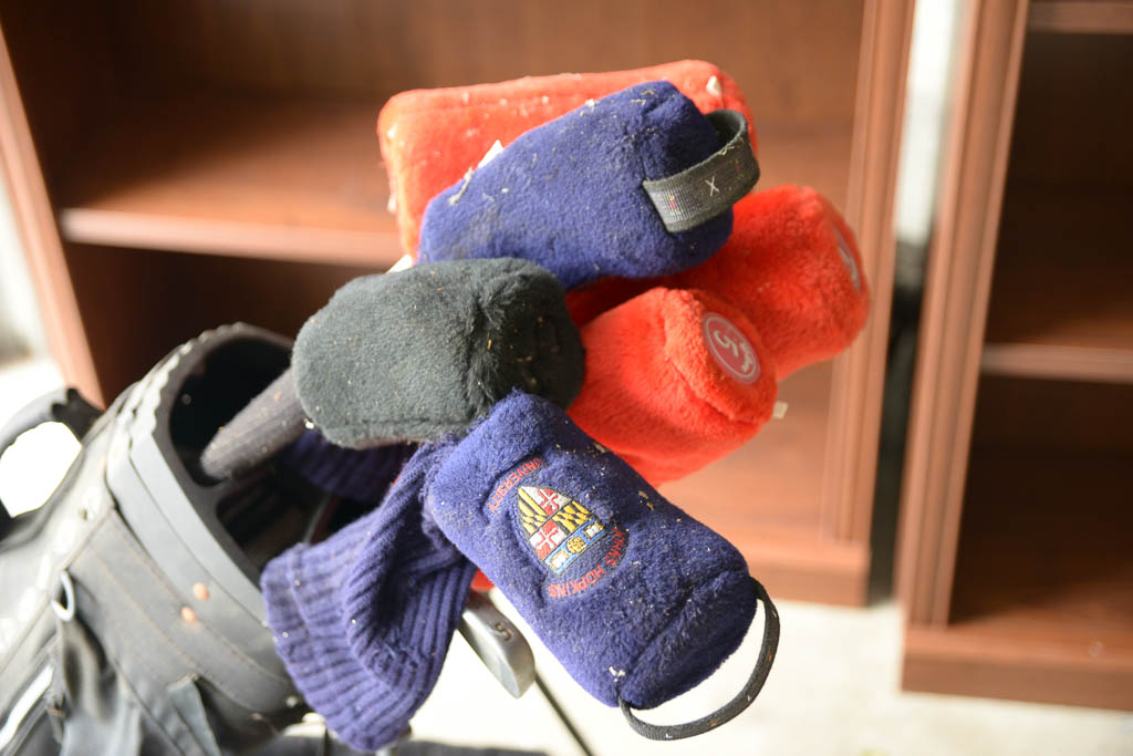 Assortment of Golf Clubs and Bags