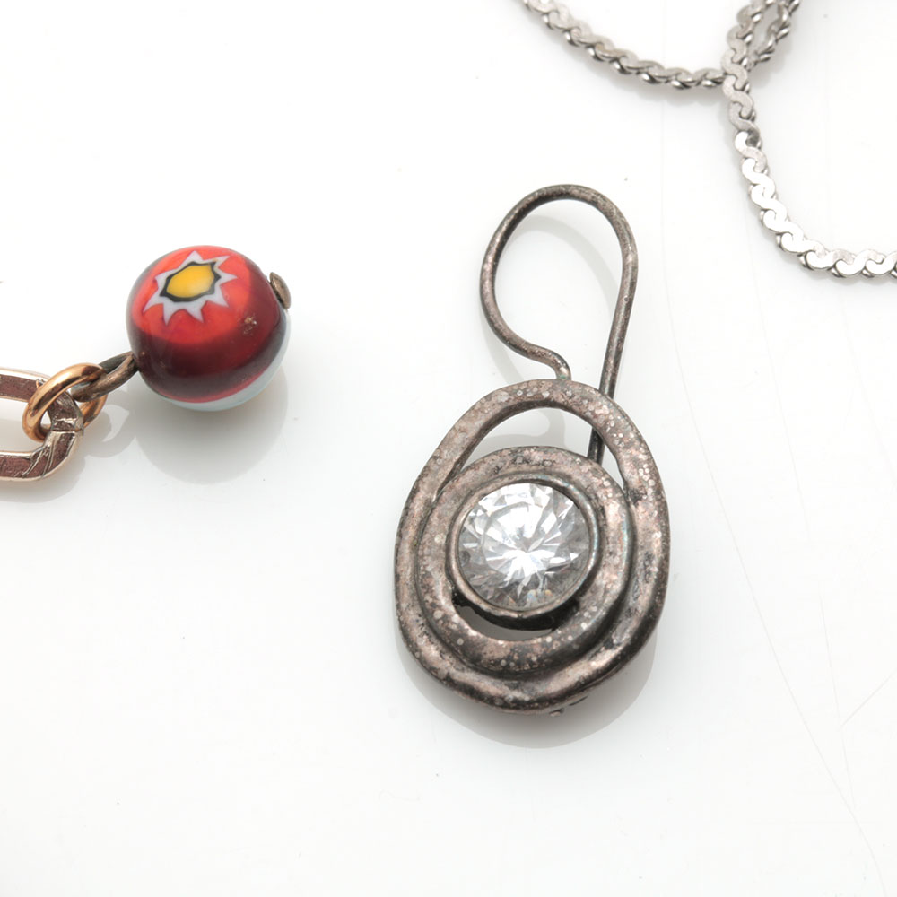 Colorful Assortment of Jewelry Featuring Sterling Silver, Shell, Rhinestones, and Imitation Millefiori