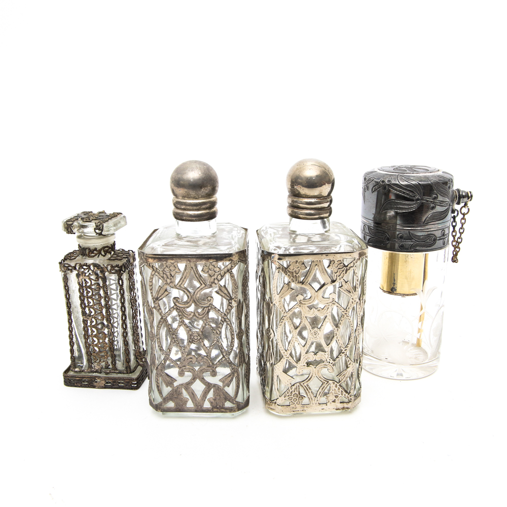 Assortment of Vintage Perfume Bottles featuring Metal Overlays