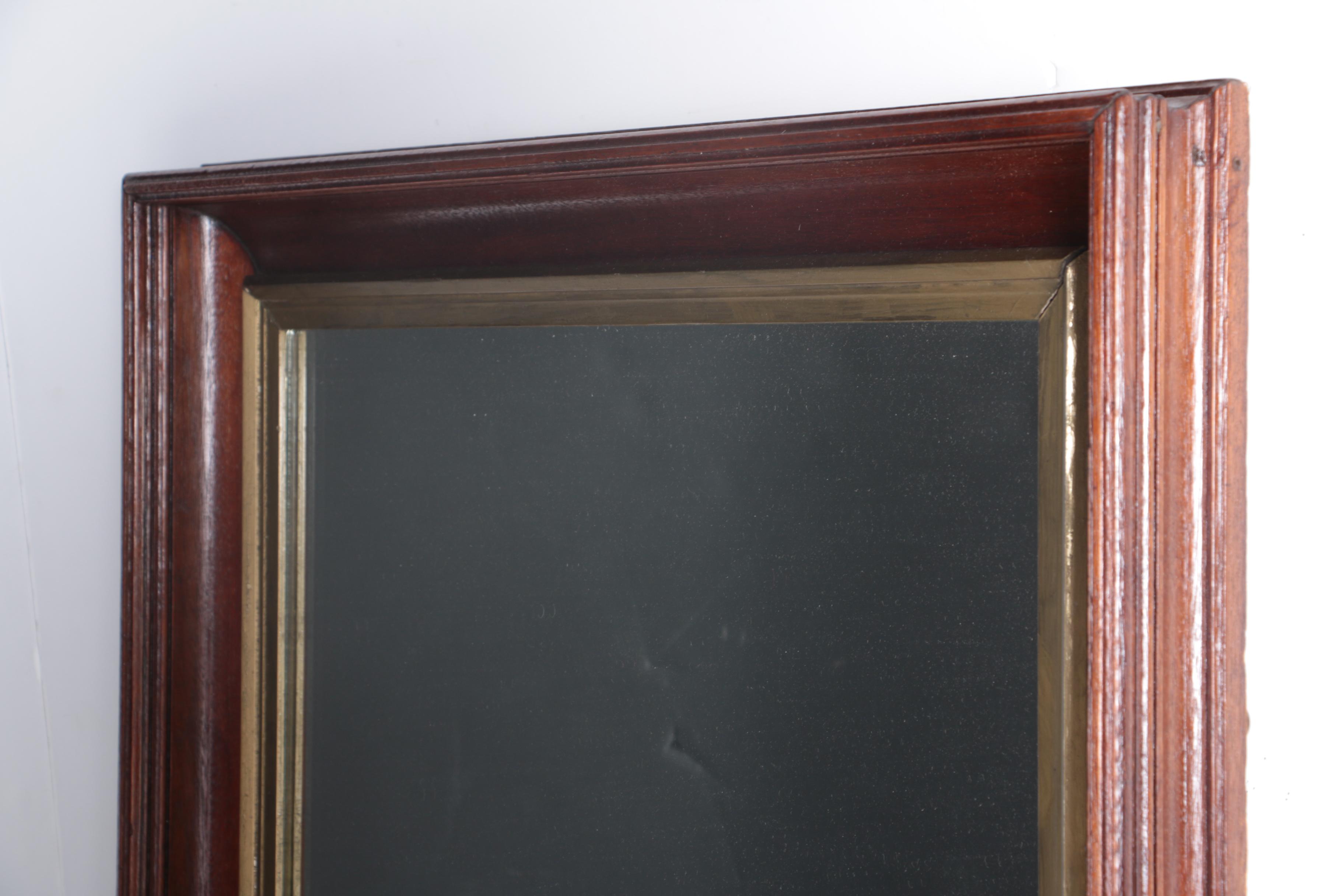 A Beveled Wood Framed Wall Mirror